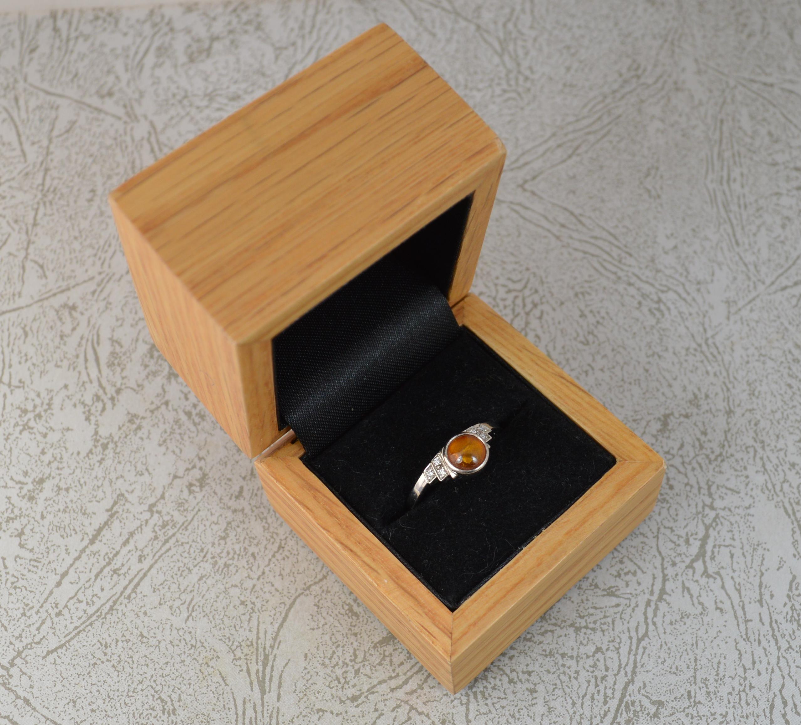 A stunning Harriet Kelsall designer ring. 
A bespoke example, a contemporary piece with art deco influence to its design.
Solid 950 grade platinum example.
Designed with a round amber to centre, 6.5mm diameter. Set with three round cut diamonds set