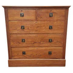 Harris Lebus an Arts & Crafts Oak Chest of Drawers with Brass Ring Pull Handles