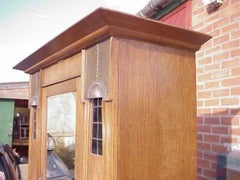 Maple & Co, An English Arts & Crafts Oak Wardrobe with Decorative Copper Details