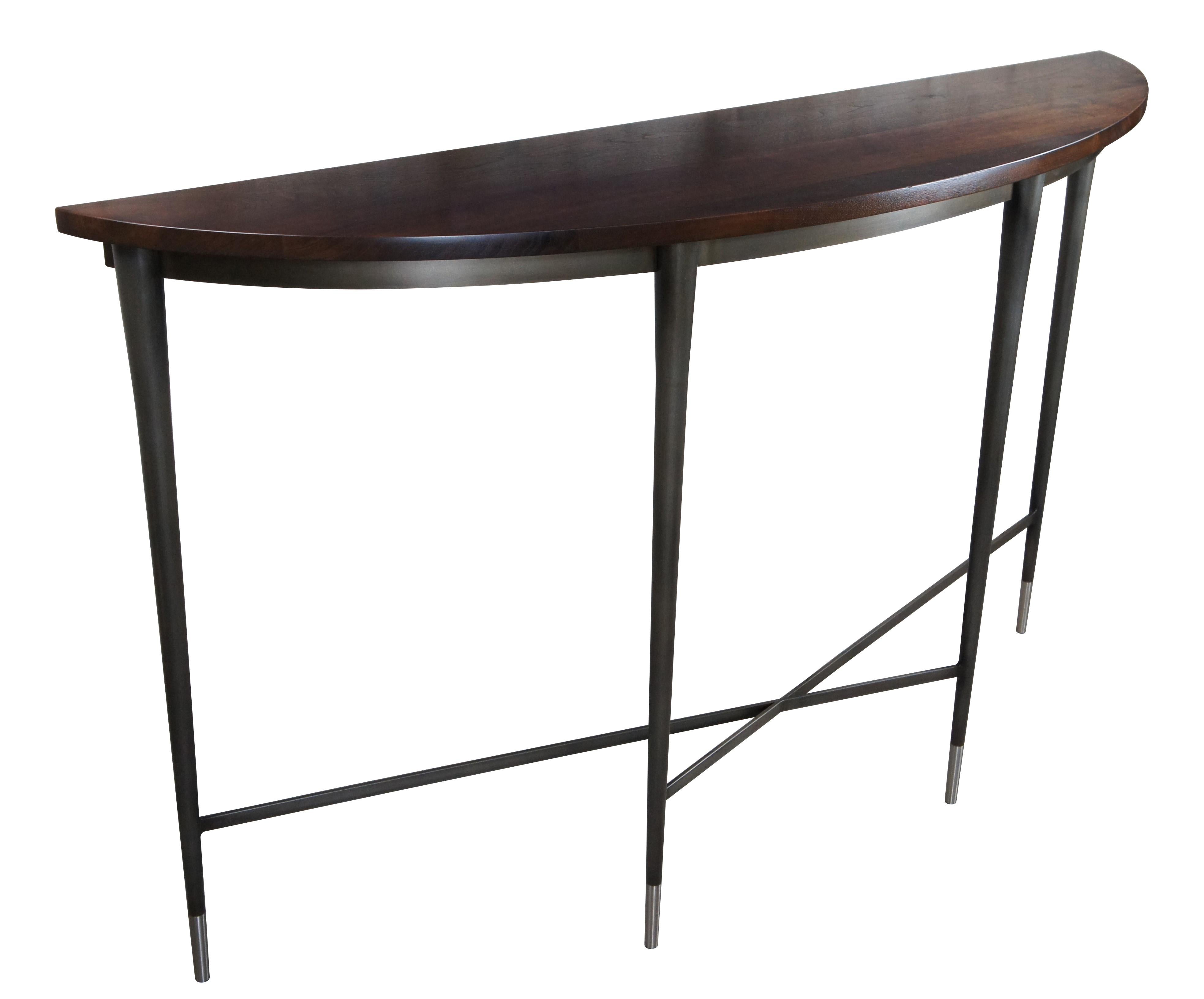 Harris Rubin McGavin console / hall / entry / side table or sideboard.  Made of walnut featuring modern demilune / bowfront form with tall tapered steel base and x stretcher. 

Dimensions:
66.6