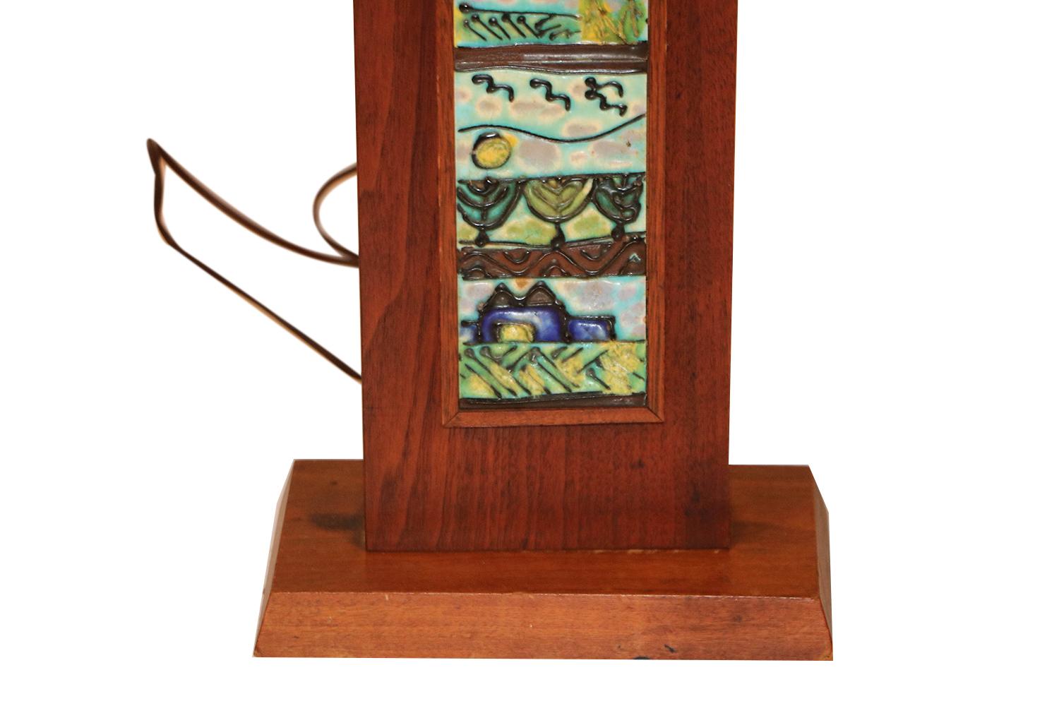 A unique and fascinating midcentury, rectangular, wood tile table lamp, designed by Harris Strong, circa 1960s. Features multicolored inlaid ceramic tiles in shades of blues and greens. Truly a rare work of art, this lamp is sure to spark curiosity