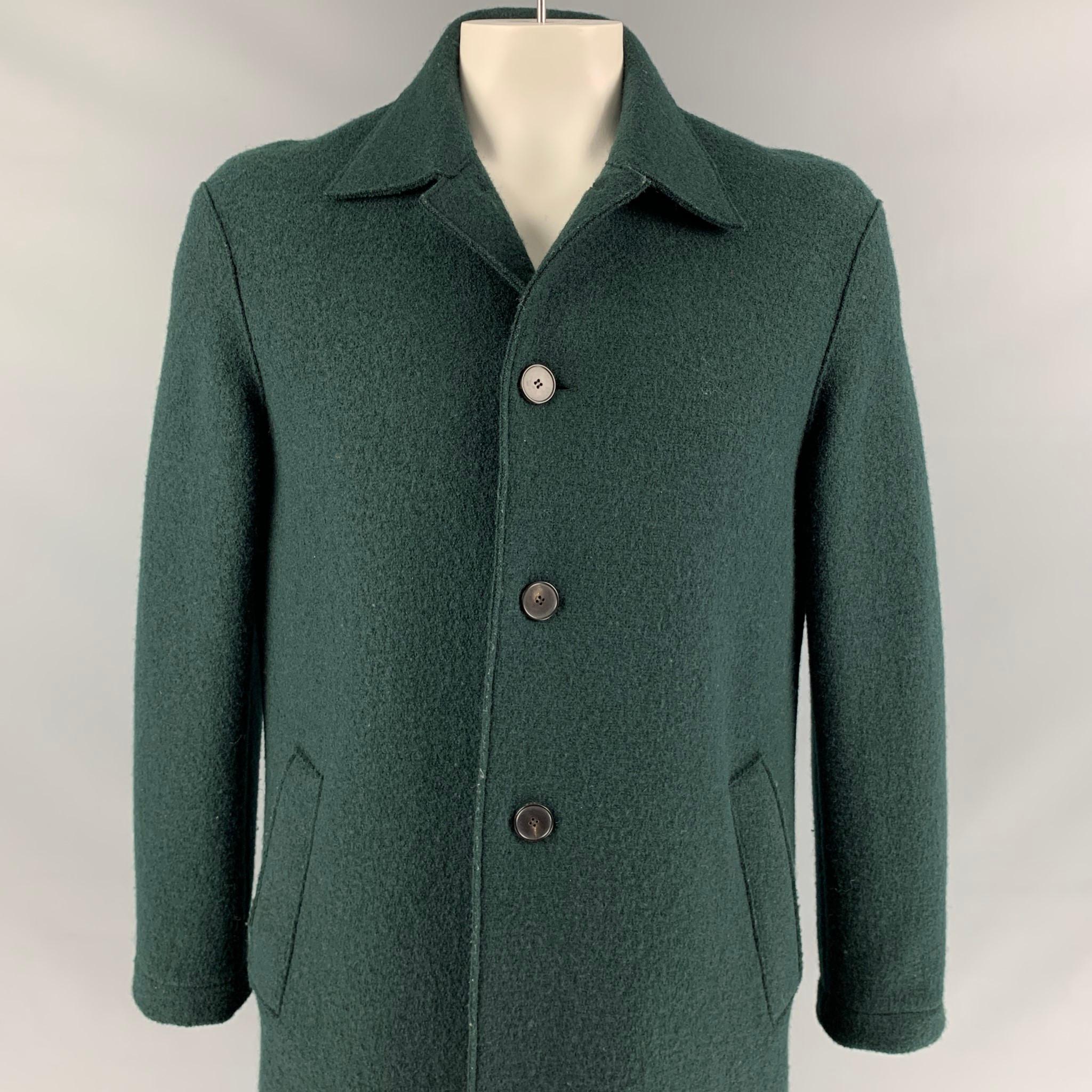 HARRIS WHARF LONDON coat comes in a forest green textured wool featuring a pointed collar, slit pockets, single back vent, and a buttoned closure. Made in Italy.

Very Good Pre-Owned Condition.
Marked: 52

Measurements:

Shoulder: 21 in.
Chest: 44