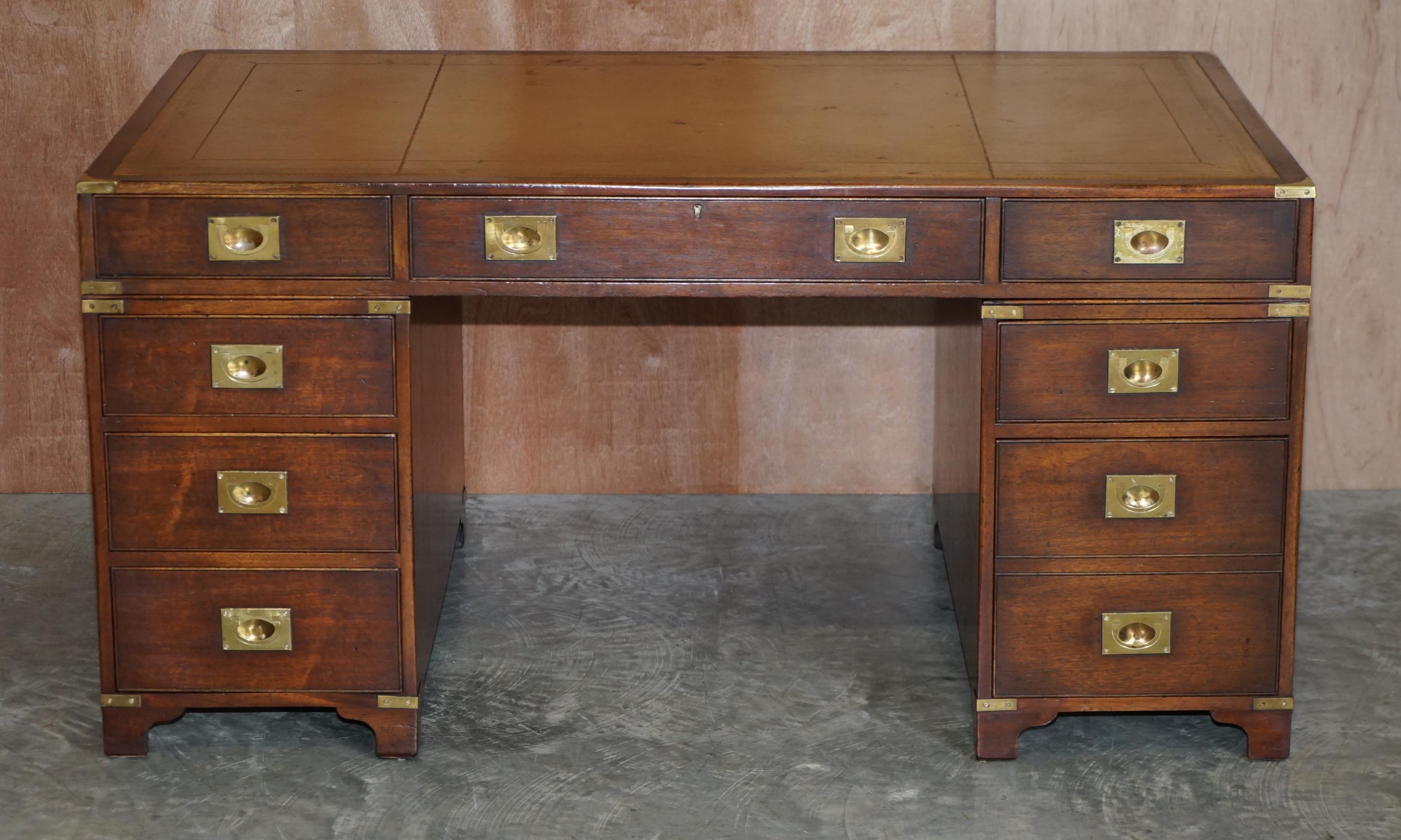 We are delighted to offer for sale this lovely hand made in England Harrods Kennedy Military Campaign twin pedestal double sided partner desk with bookcase back and brown leather writing surface

This desk is an original twin pedestal partner desk