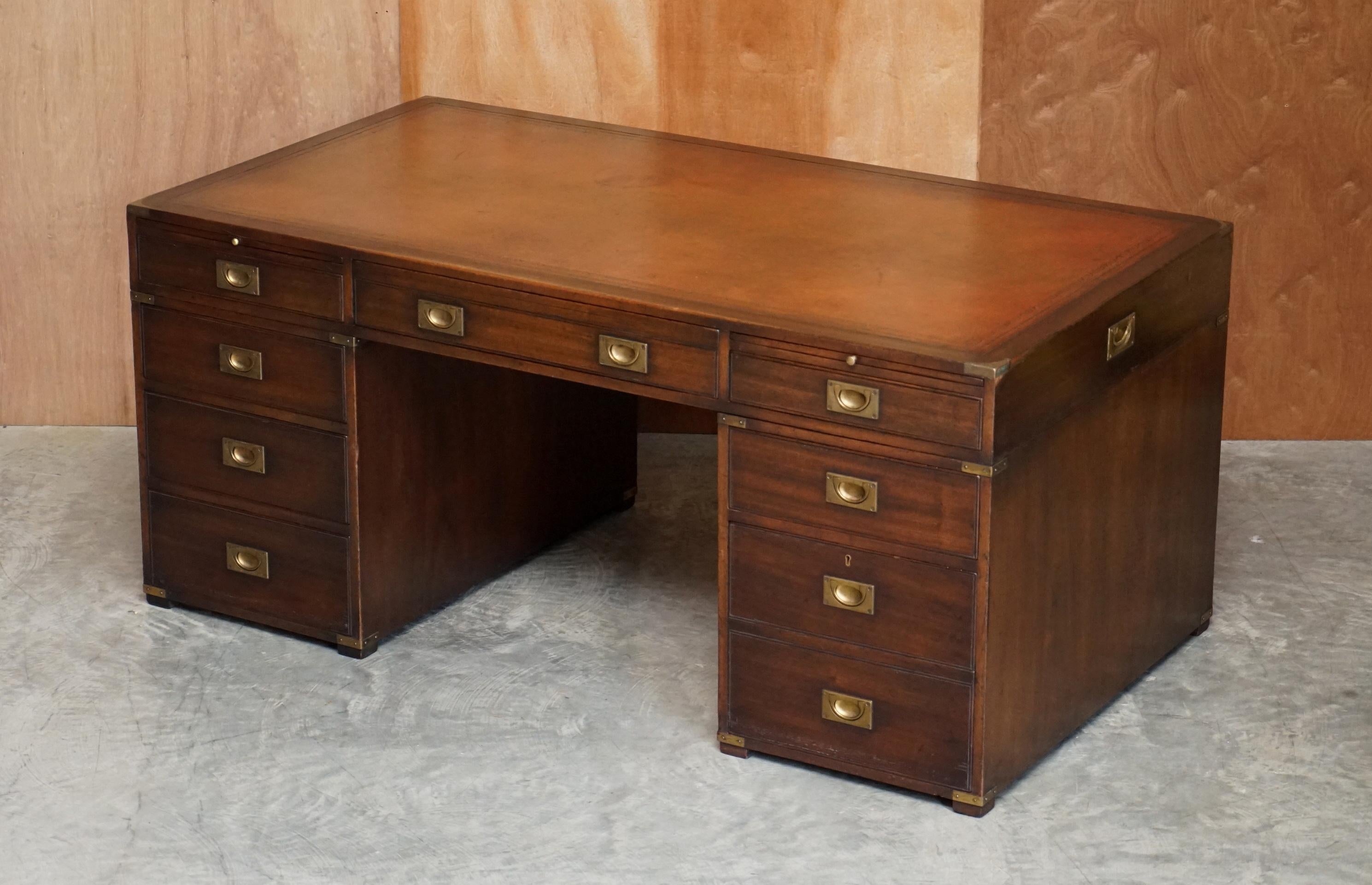 We are delighted to offer for sale this lovely hand made in England Harrods Kennedy Military Campaign twin pedestal double sided partner desk with bookcase back and brown leather writing surface

This desk is an absolutely stunning piece. The