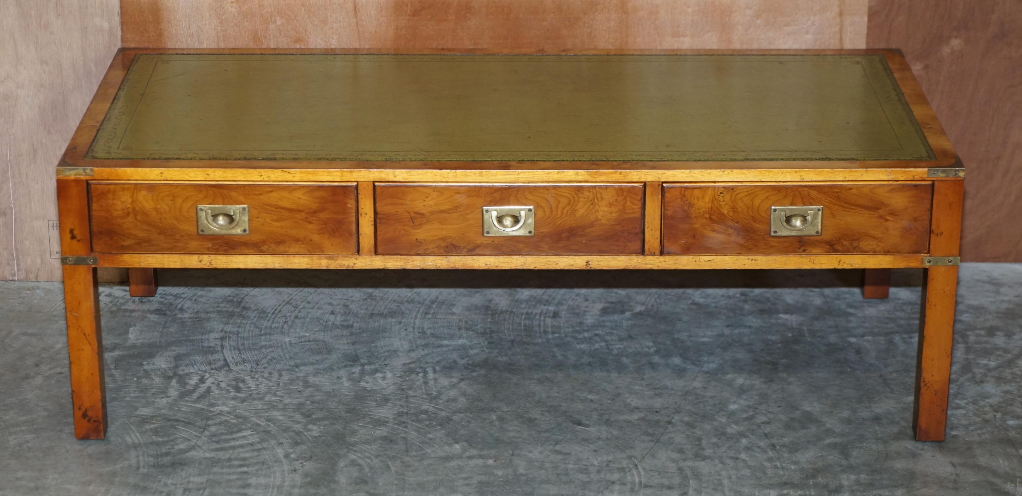 We are delighted to offer for sale this vintage collectable Harrods London Military Campaign three drawer coffee table made by Kennedy with green leather top in Burr Elm

This piece was sold through Harrods approximately 20-30 years ago, it was