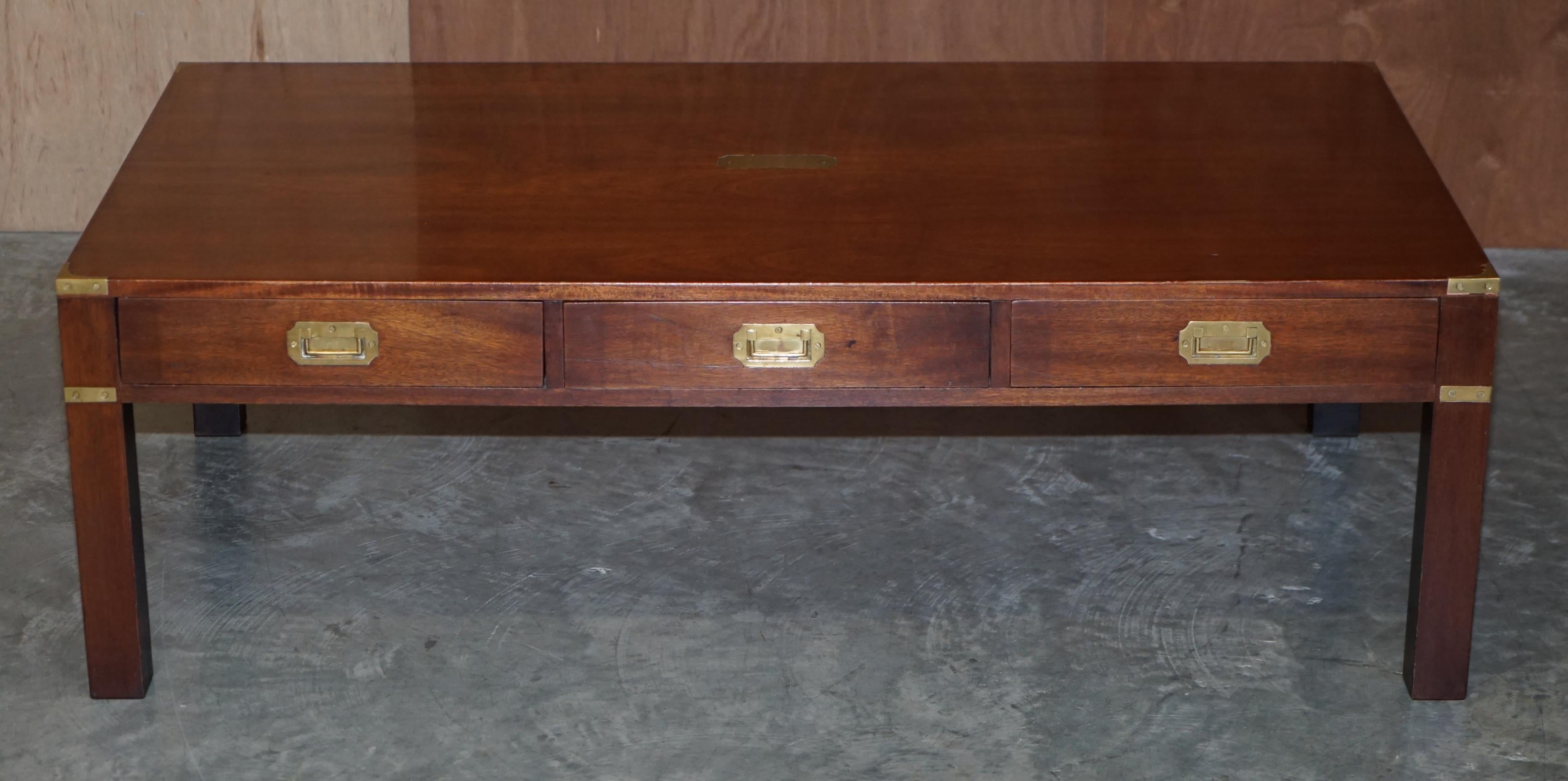 We are delighted to offer for sale this very large Harrods London Military Campaign three drawer coffee table made by Kennedy.

This piece was sold through Harrods, it was made by Kennedy who were Harrods oldest concession, they retailed with them
