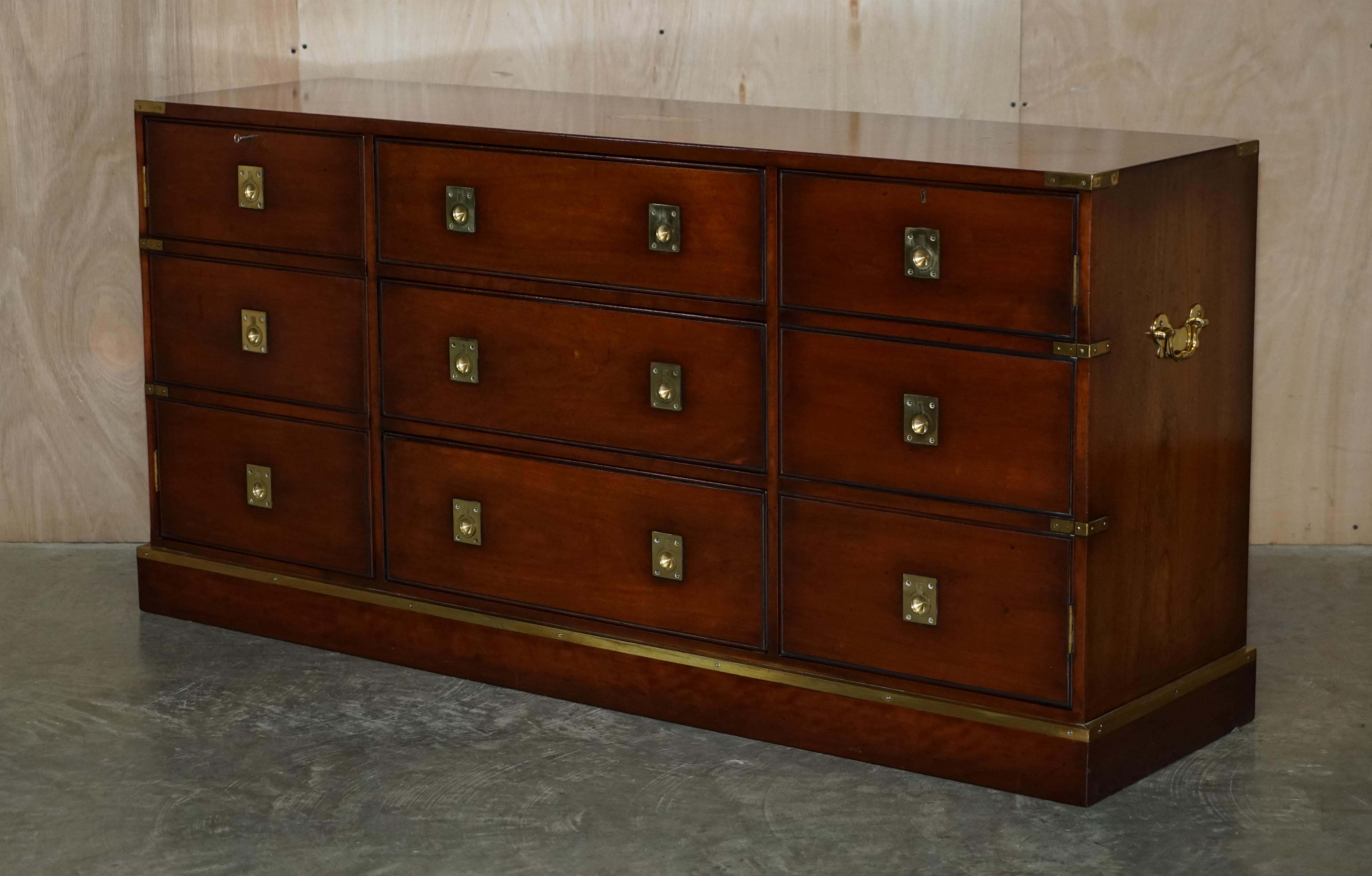 We are delighted to offer for sale this lovely vintage solid mahogany with brass trim Military Campaign sideboard with three drawers and two cupboards made by REH Kennedy and retailed through Harrods London

A very well made and decorative piece,