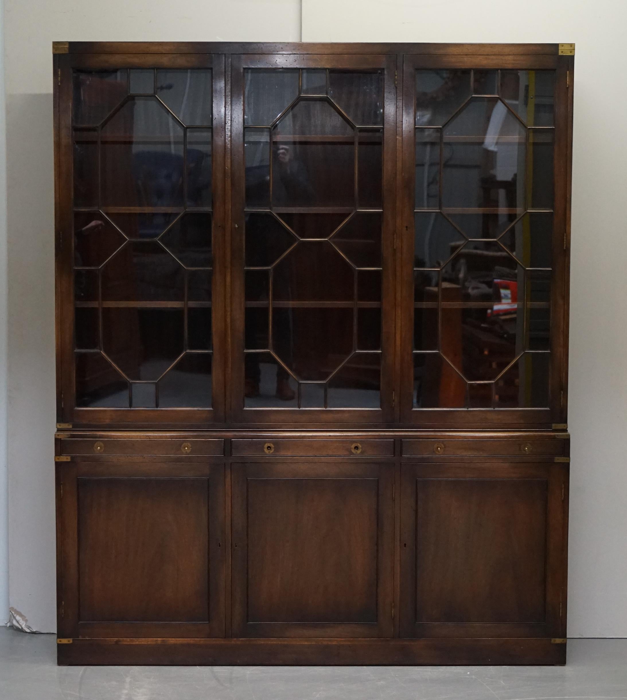 We are delighted to offer this stunning Harrods London Military Campaign Astral Glazed Library Bookcase with green leather writing desk slide

A very good looking well made and decorative bookcase. Retailed through Harrods London, it’s made in the