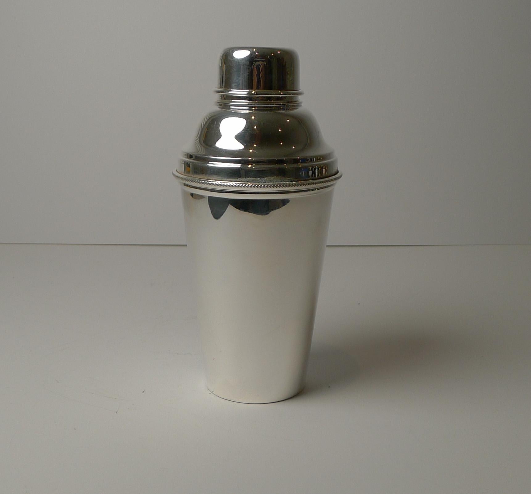 Always highly sought-after and hard to find, this vintage Art Deco cocktail shaker has an integral Lemon squeezer or reamer built into the top section of the shaker.

Made from English silver plate, it is fully marked on the underside for the