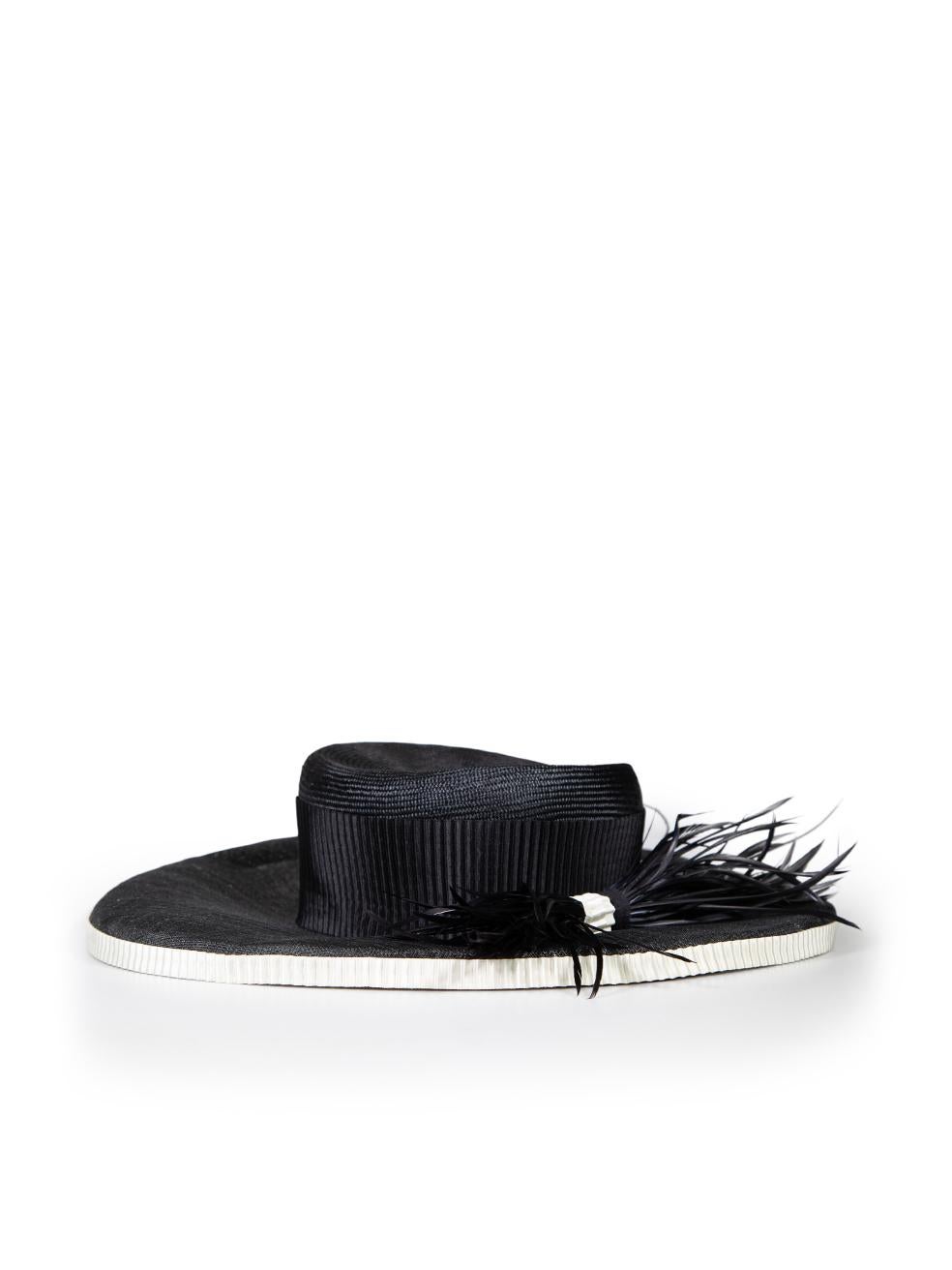 CONDITION is Very good. Minimal wear to hat is evident. Minimal discolouration on the label on this used Harrods designer resale item.
 
 
 
 Details
 
 
 Vintage
 
 Black
 
 Synthetic
 
 Sun hat
 
 Feather detail
 
 White ribbon trim
 
 
 
 
 
