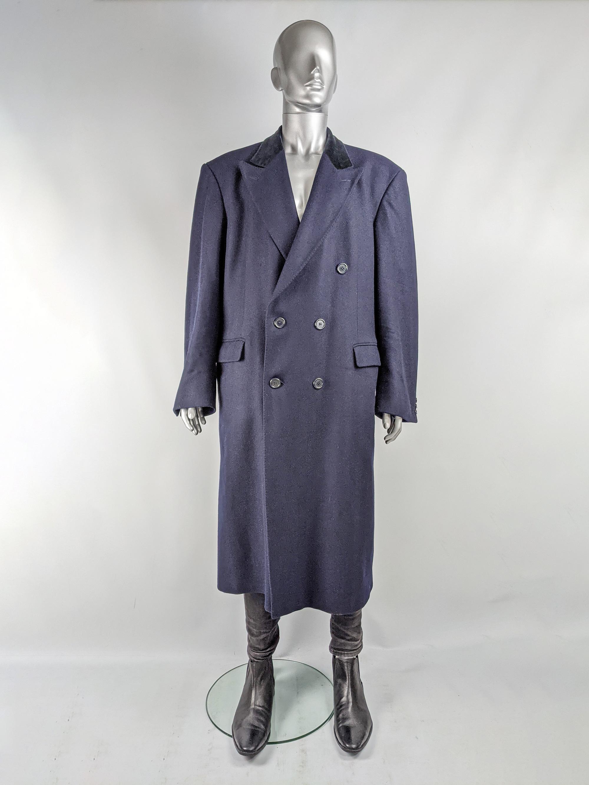 A classic vintage men's Harrods overcoat from the 80s in a dark navy blue wool and cashmere with a blue velvet collar and bold shoulders for an ultra masculine look. 

Size: Marked 46 Long which is roughly a mens 3XL
Chest - 48” / 122cm (allow