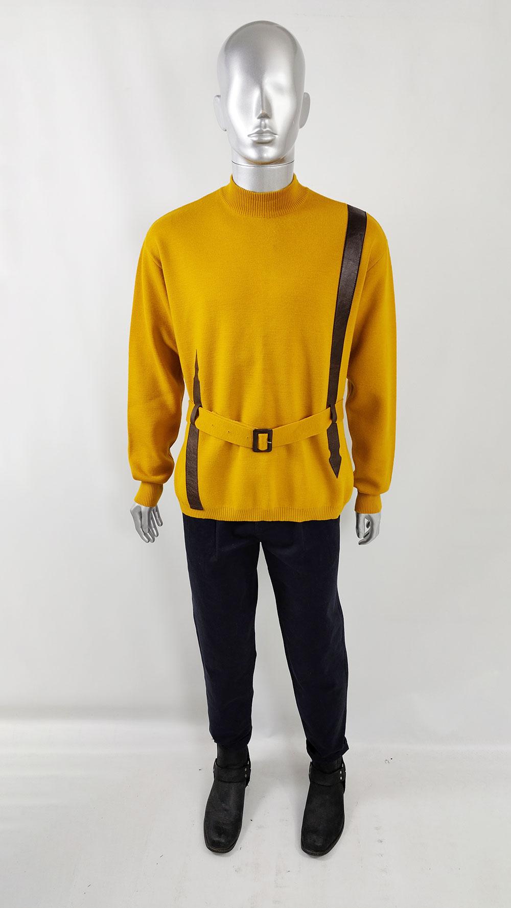 A superb and rare men's vintage jumper from the 1960s by the luxury British department store, Harrods. Crafted in mustard yellow pure wool, the jumper features dark brown vinyl appliques and a remarkable belt that imparts a retro space-age