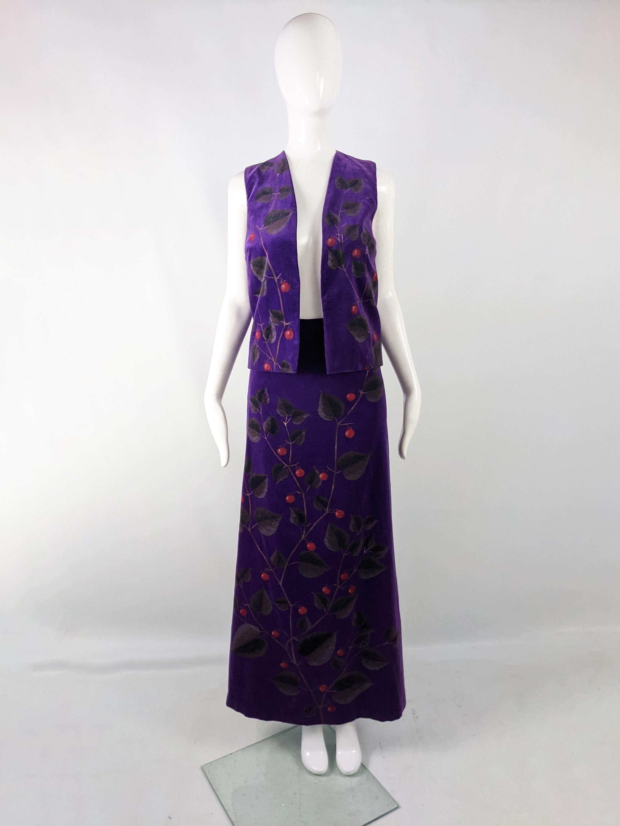 An incredible vintage womens two piece suit from the 70s by British designer Elizabeth Thirlby for luxury department store, Harrods. In a purple cotton velvet with a striking hand printed botanical print throughout. This set consists of an open