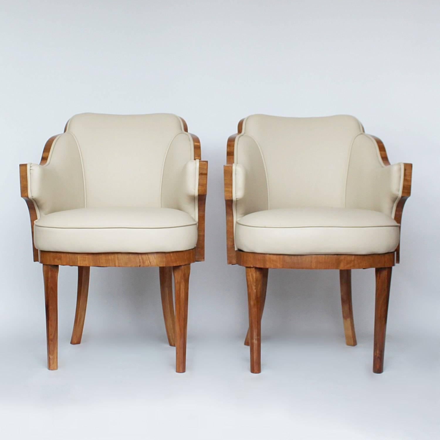 A pair of cloud form, Art Deco chairs by Harry & Lou Epstein. Walnut wrapped. Upholstered in cream leather.

Dimensions: H 84 cm, W 62 cm, D 62 cm, Seat H 49cm, Seat D 49cm.
   