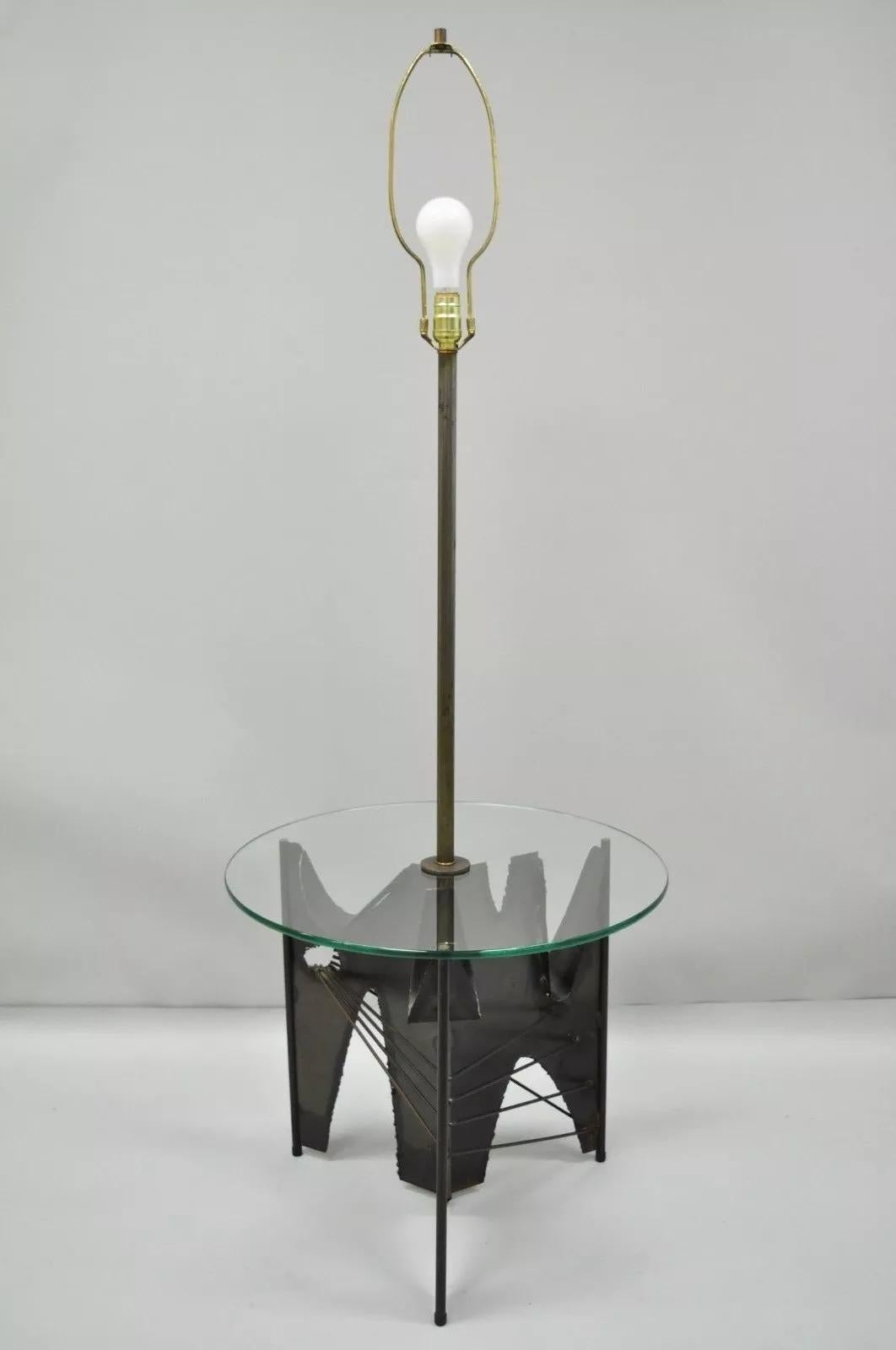 Vintage Mid Century Modern Harry Balmer for Laurel Brutalist Floor Lamp Side Table. Item features a 3-way switch, steel metal brutalist tripod base, round glass surface, great style and form. Circa Mid 20th Century. Measurements: 59