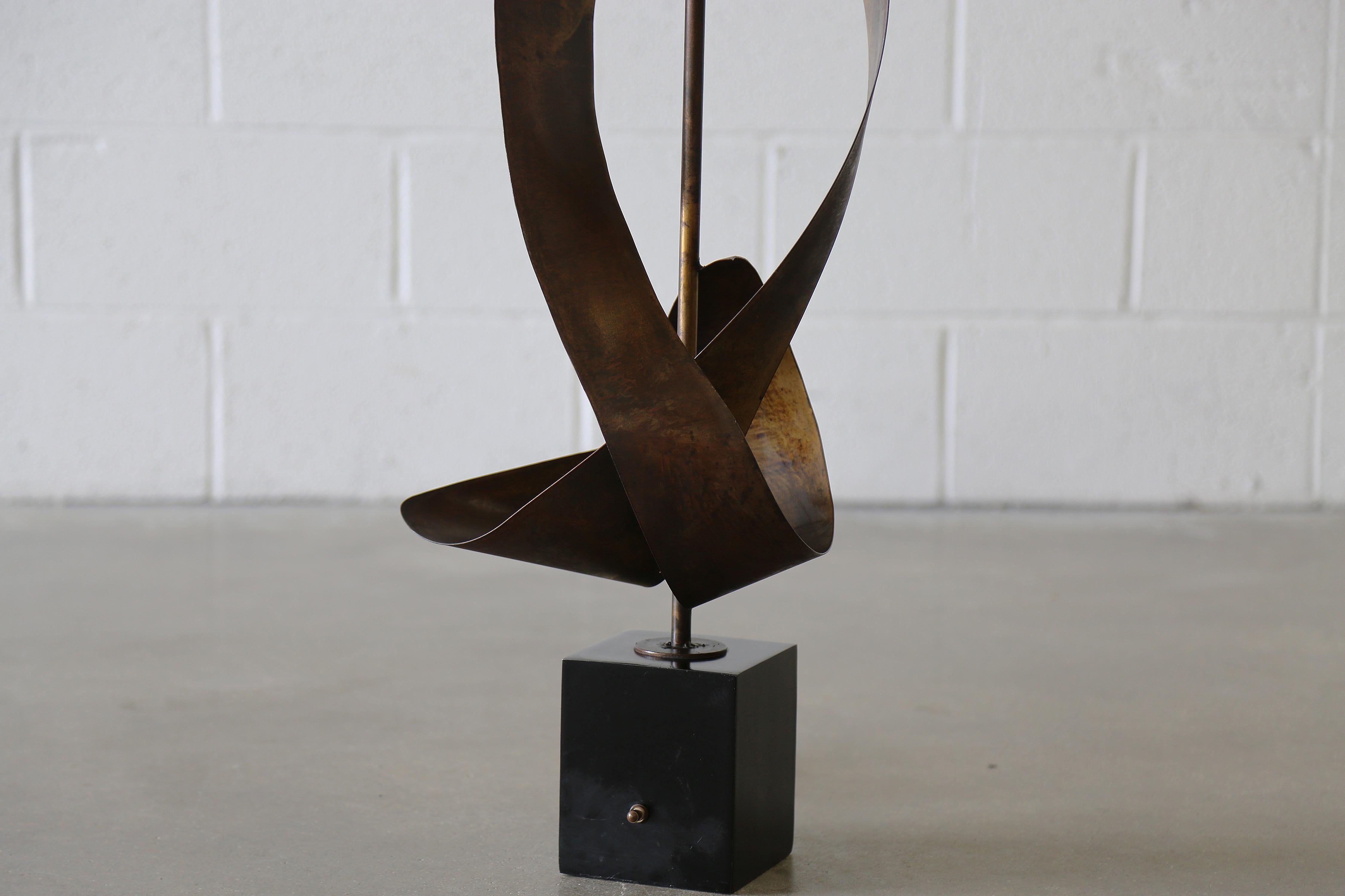 Striking Mid-Century Brutalist ribbon-form table lamp by Harry Balmer for Laurel Lamp Co., circa 1960s. This lamp features a sculptural patinated steel body on a black metal base. A bold, functional statement piece. This mid-century anomaly