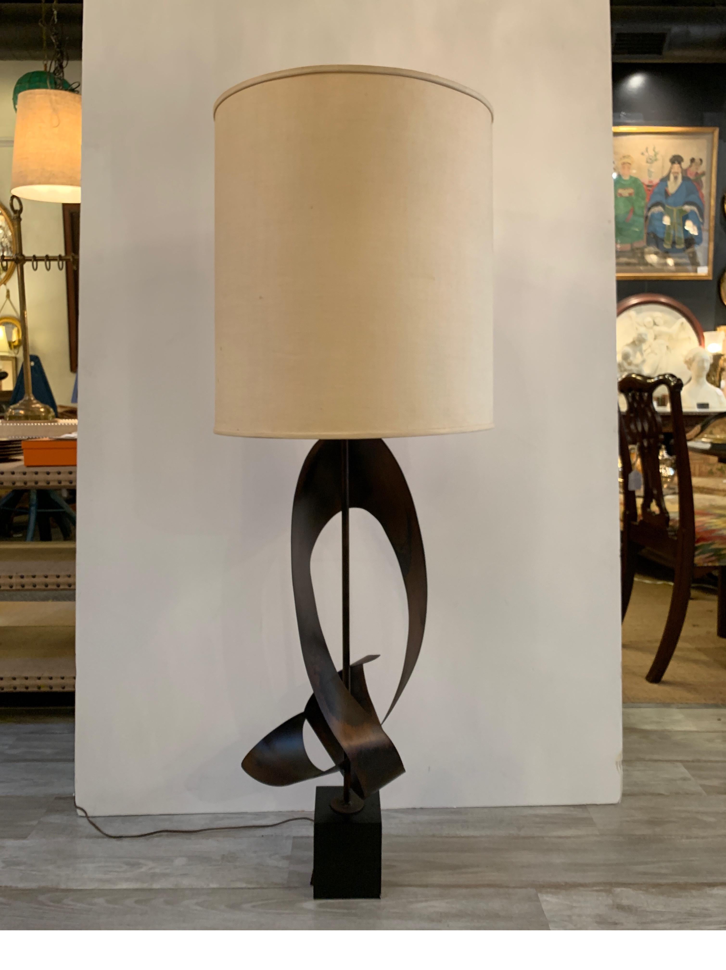 Artistic metal sculptural ribbon lamp designed by Harry Balmer. The weathered oiled finish with lamp with a black cube base. The shade is for photographic purposes only and not included but easily added for the next owner. The lamp to the top of the