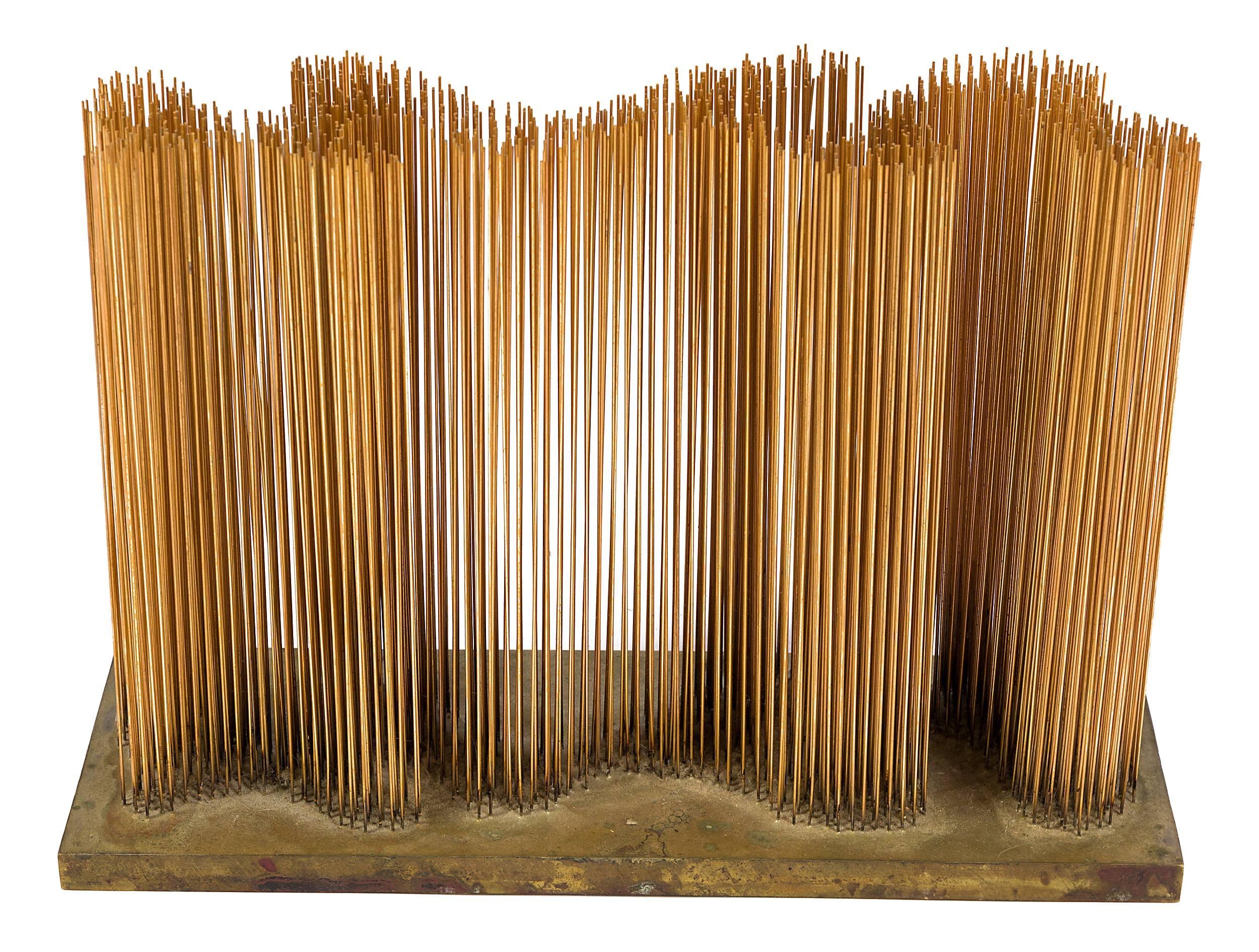 A sounding sculpture with straight vertical rods placed in an undulating wave pattern on a flat base. One of the rare small fine wire sonambients that produce a distinctive resonant sound.