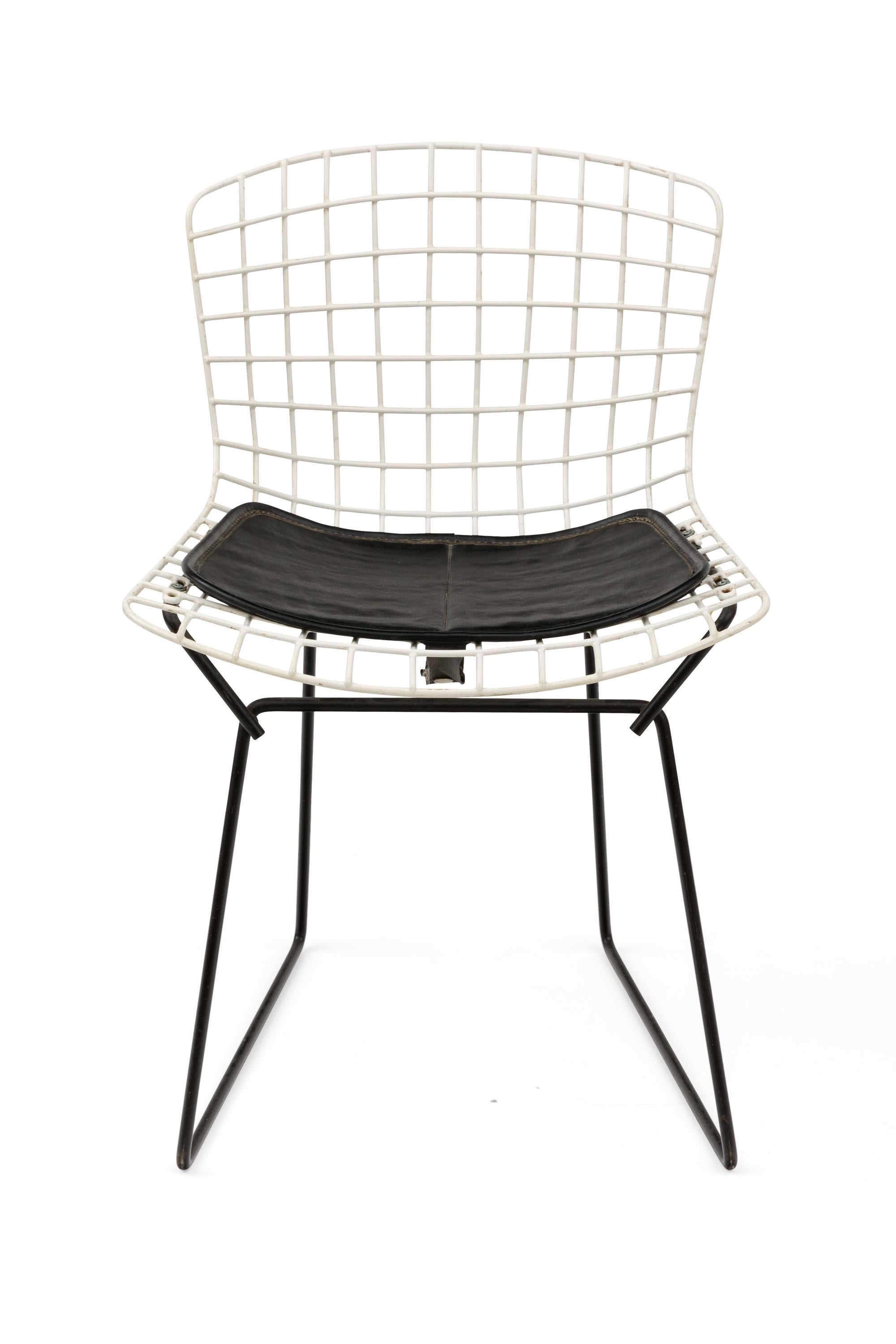 A universally recognized design, these Bertoia child's chairs have black bases and the original seat pads.