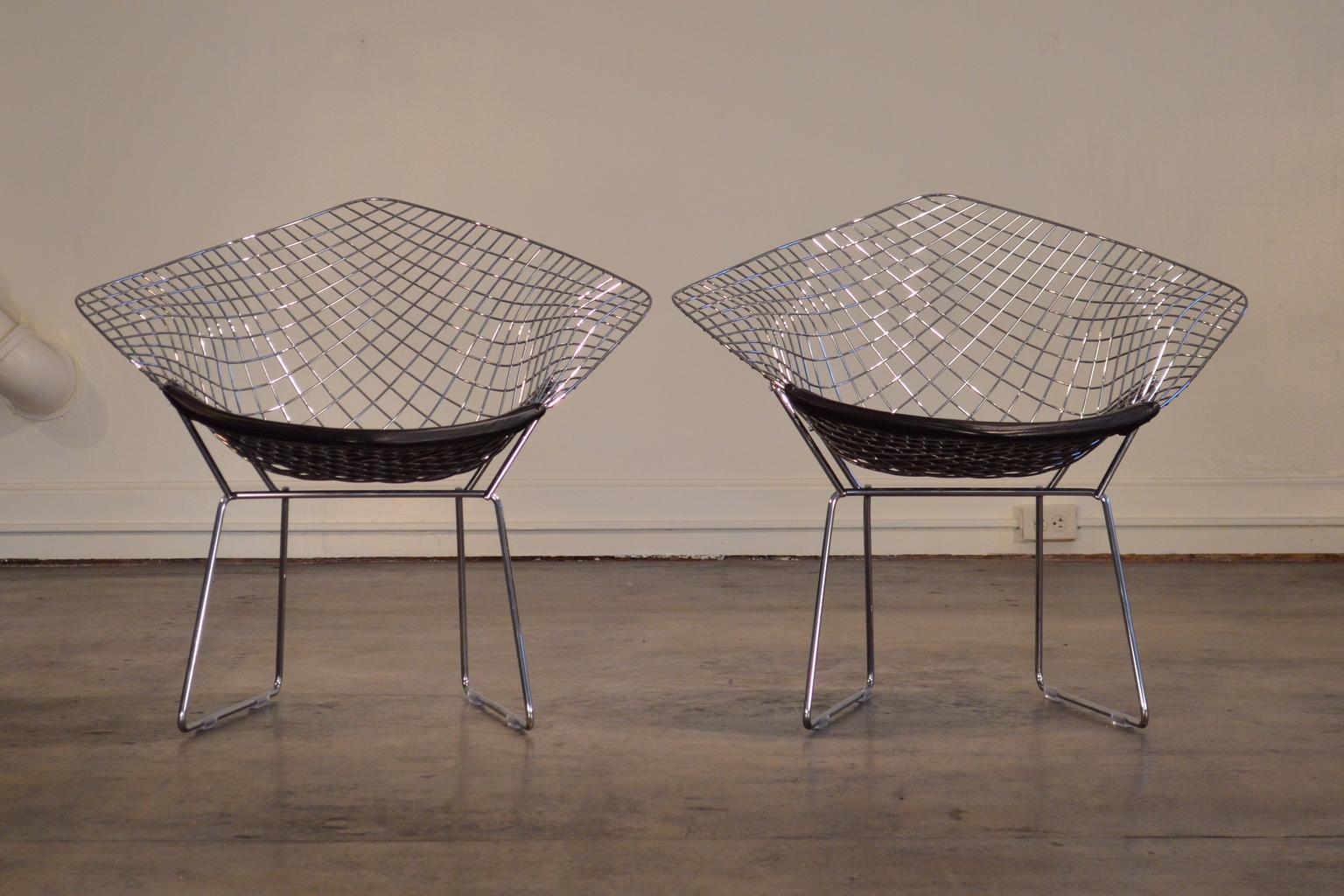 Authentic Harry Bertoia Diamond chairs made by Knoll, circa 1985. Bertoia's wire chair designs are evergreen icons, and the Diamond chair remains distinctive and striking through the decades.

This pair's attributed vintage is 1985 - in years