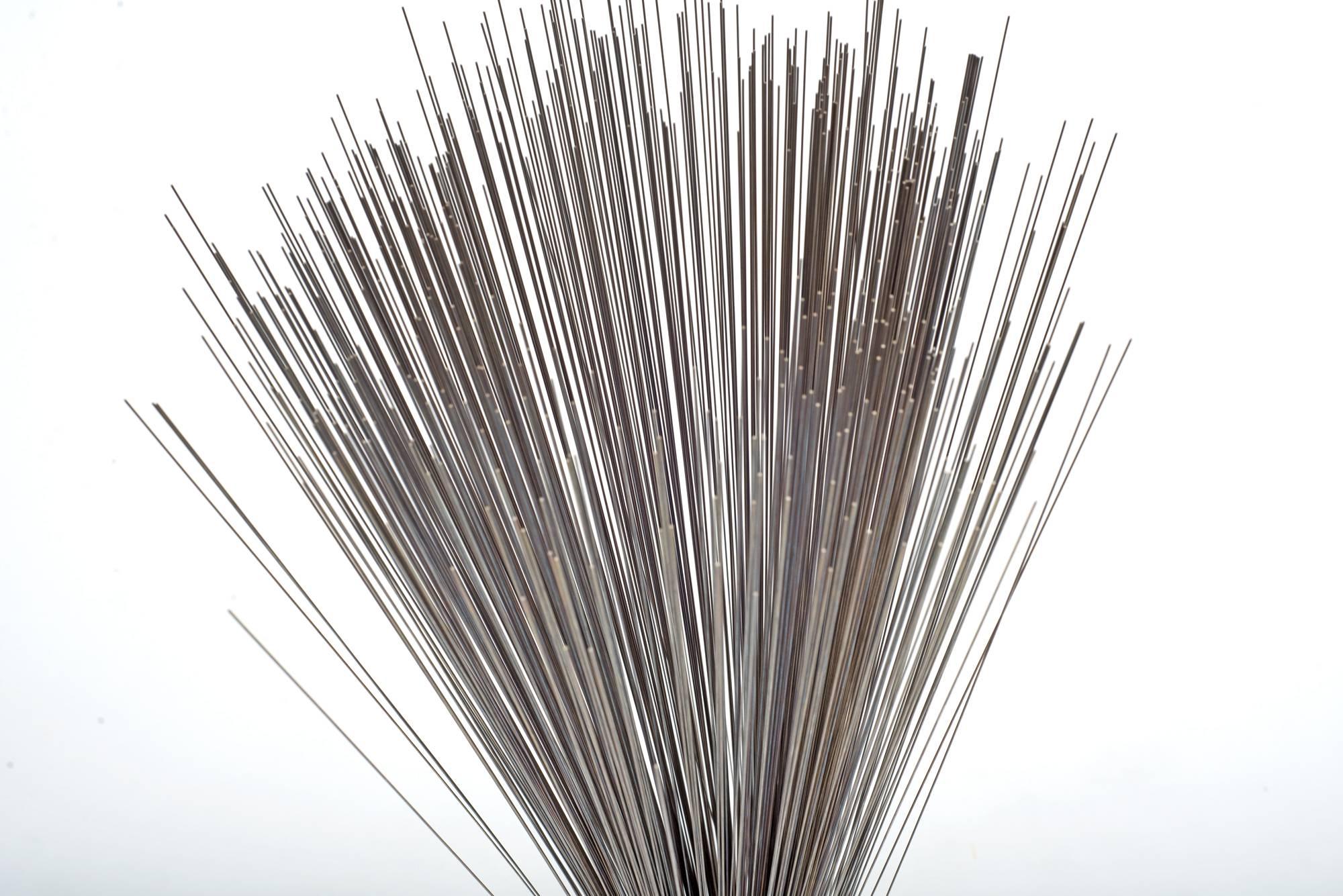 Early example of the iconic spray sculpture by Harry Bertoia. A bundle of stainless steel wires are gathered and inserted into a heavy base. The loose ends are left to drape gracefully, creating the namesake 