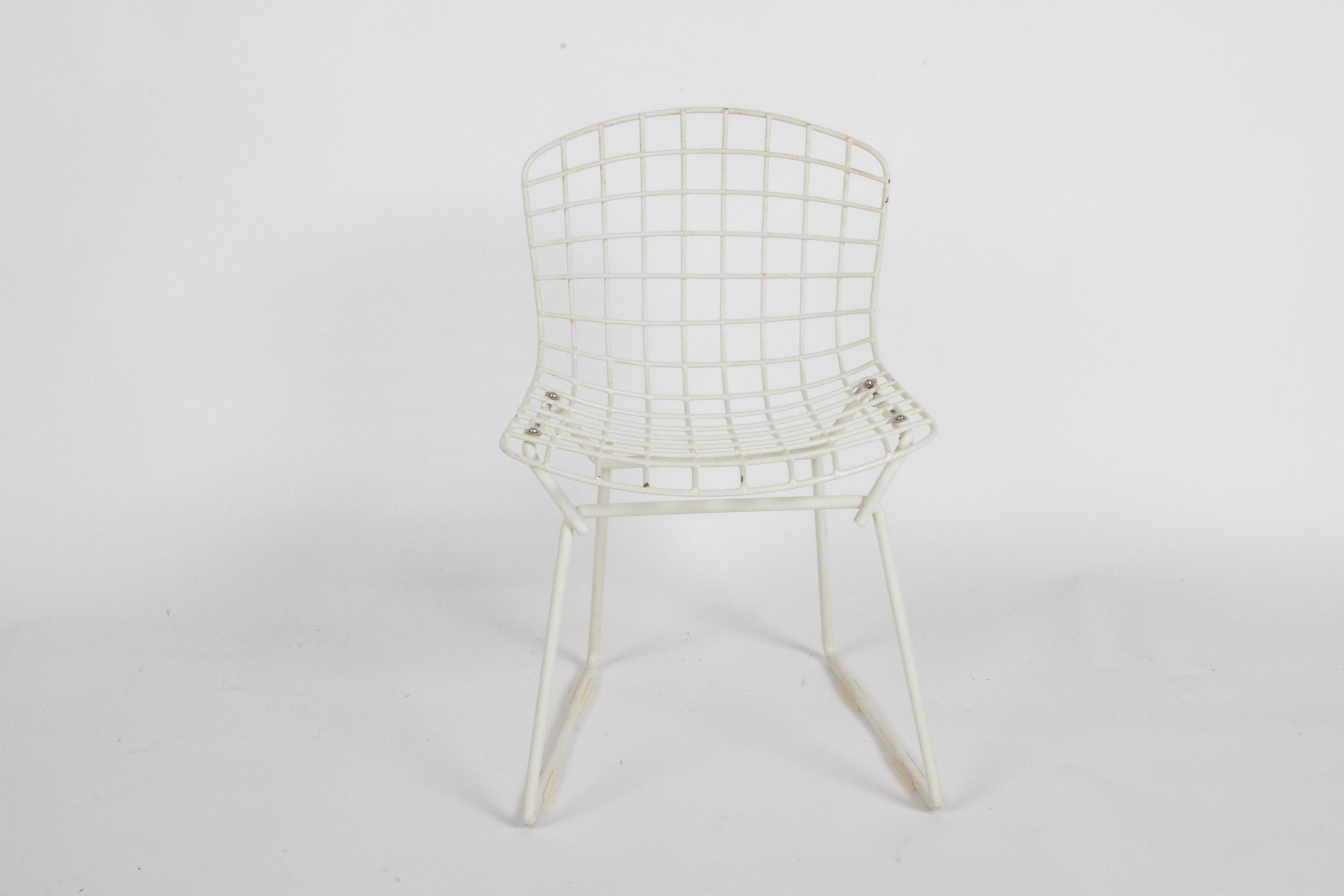 Early Harry Bertoia for Knoll child's wire coated mesh chair. In vintage condition, with some loss to coating, stains, crazing and having all four original floor glides.