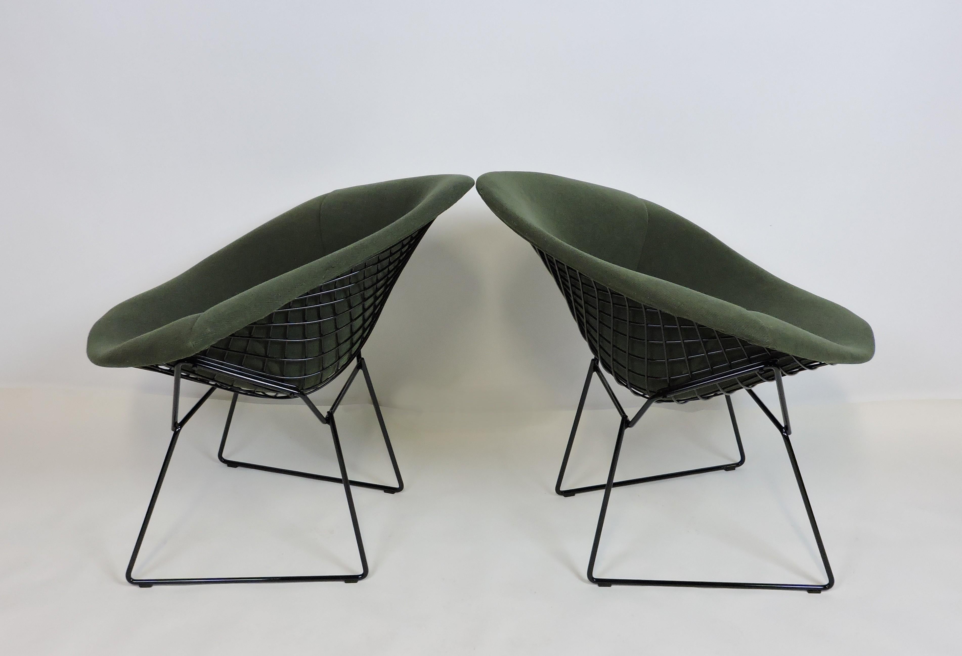Classic wire diamond chairs designed by Harry Bertoia and manufactured by Knoll. These chairs have the original full covers in a lovely green fabric and have been freshly powder coated in a black gloss finish. Knoll labels on covers and Knoll stamp