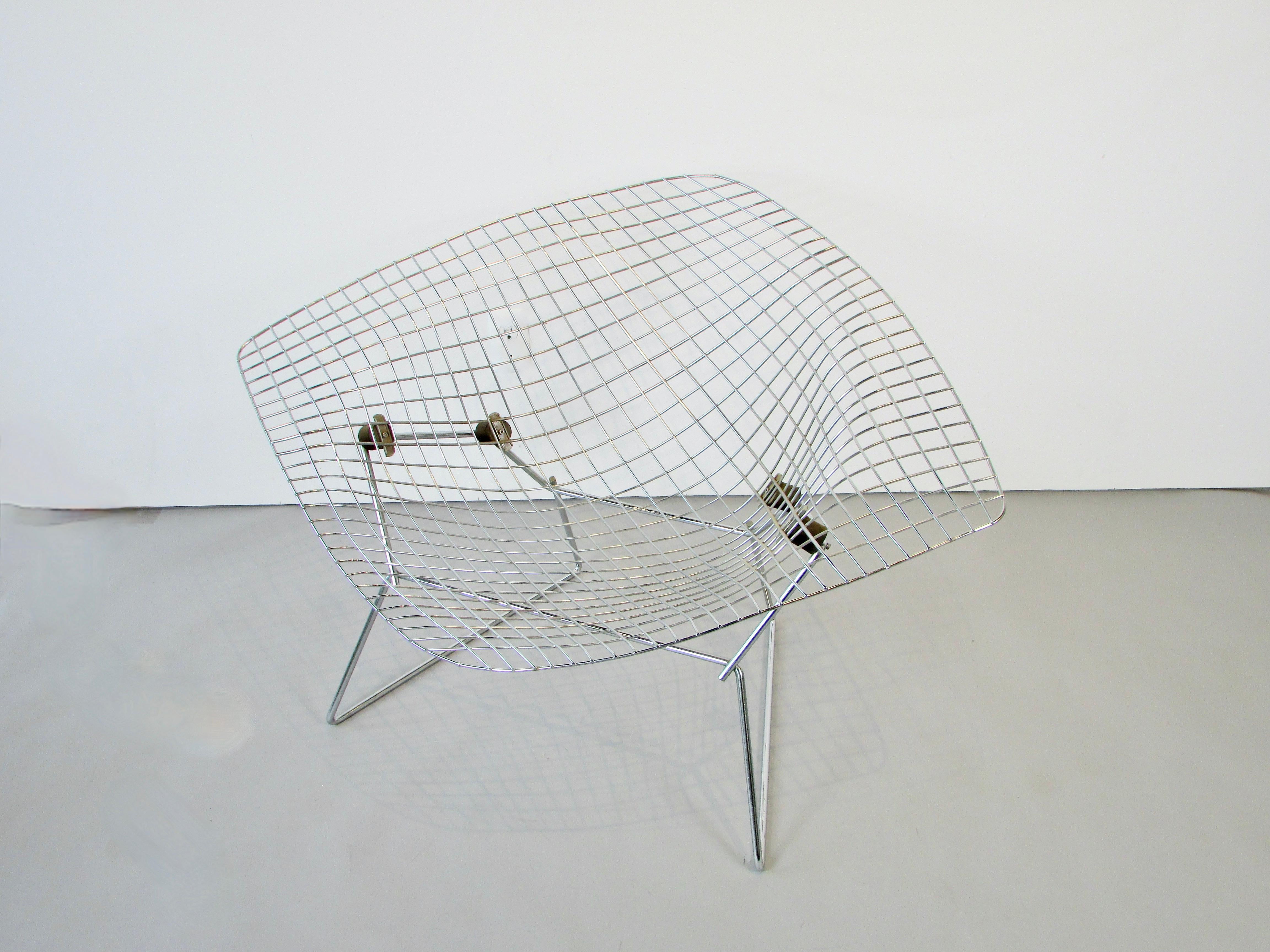 Harry Bertoias concept of woven welded steel wire was to present a chair appearing lighter than air. This is the large diamond chair from his wire series for Knoll. Chrome plated seat floats on four rubber shock mounts tattached to chrome plated