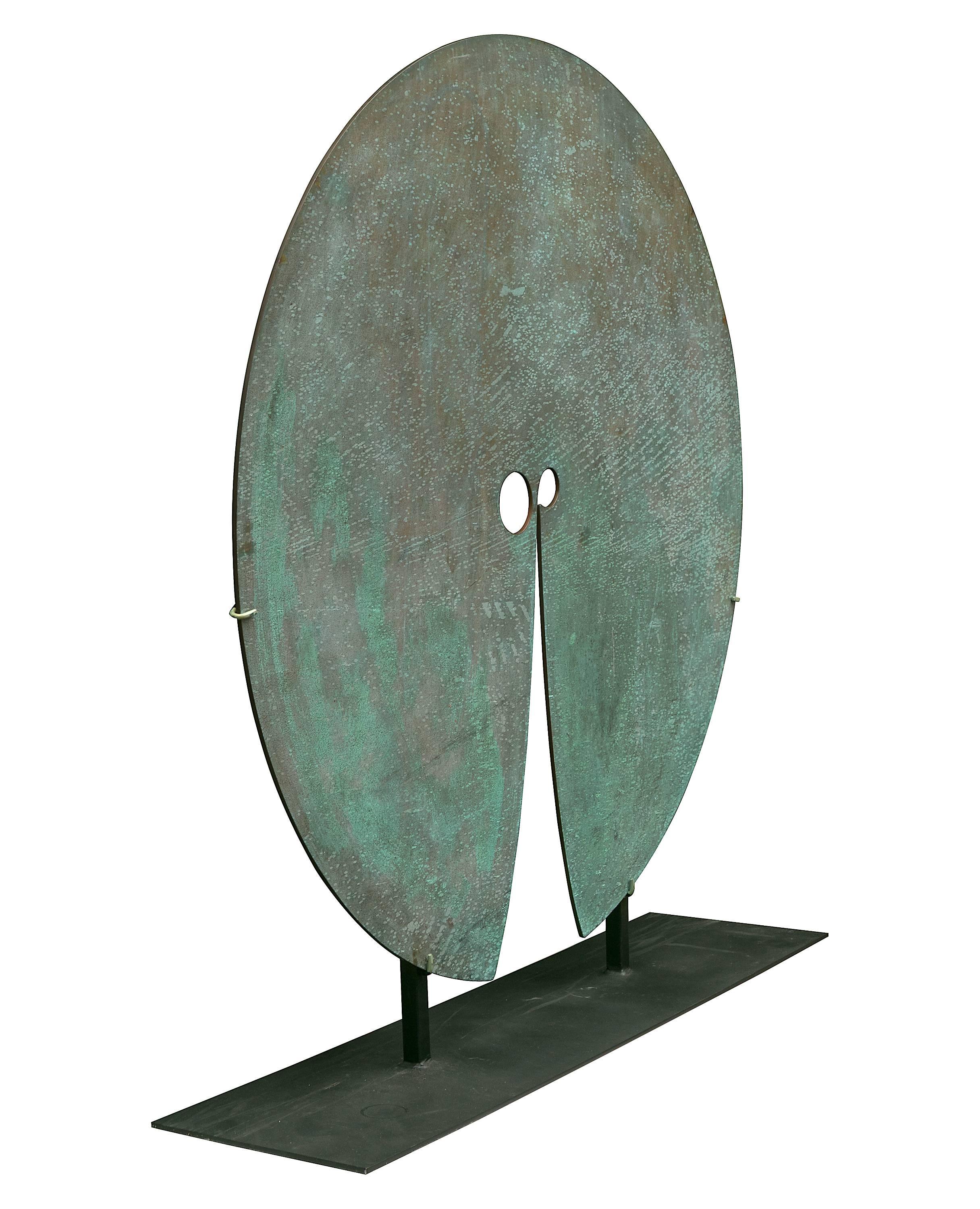 This large scale work measures 4' in diameter with gracefully arcing cuts creating divergent planes from the nearly unbroken circle. It is mounted in a stand for display purposes but when hung properly can also be sounded.