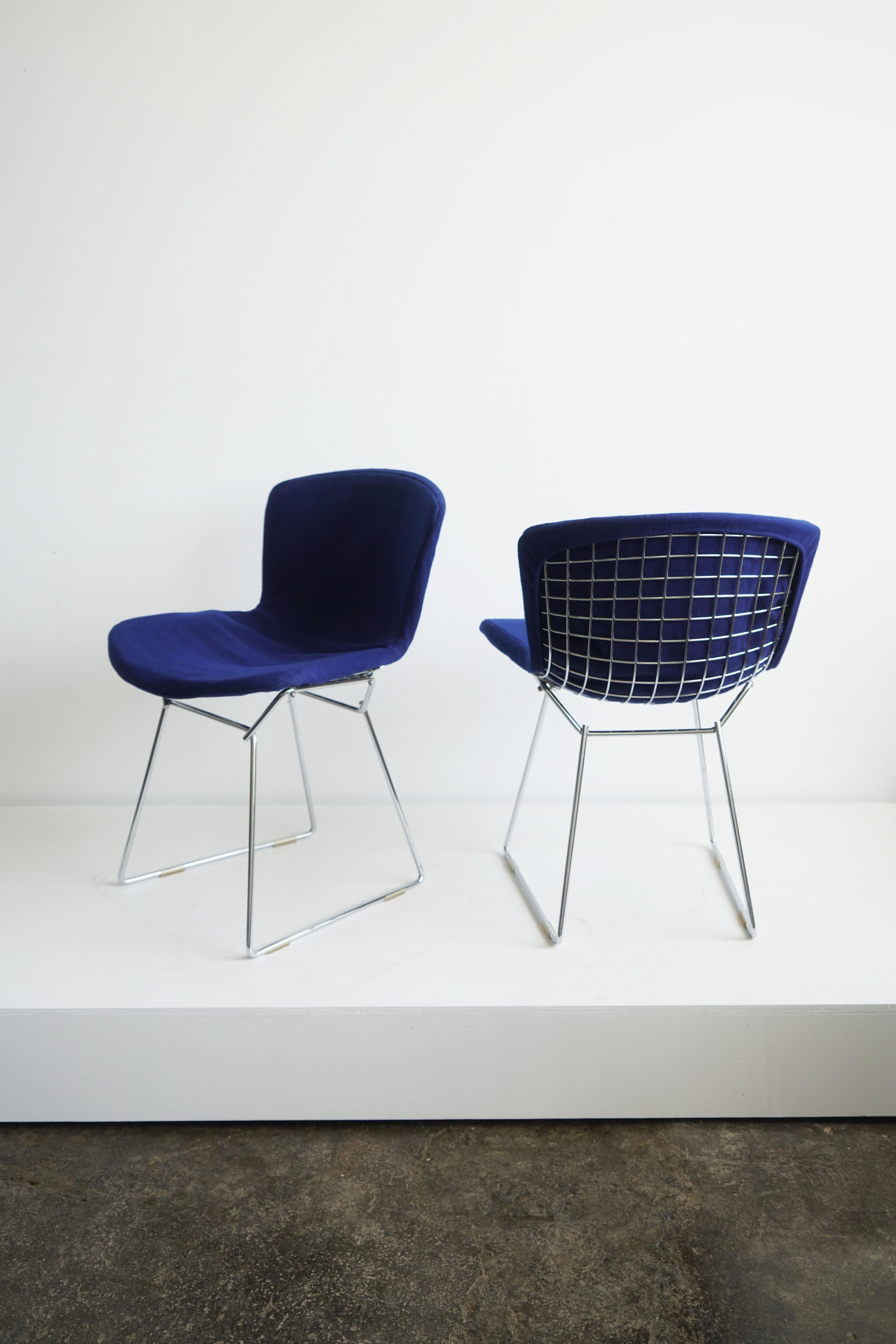 Pair of Harry Bertoia side chairs
by Knoll International, 1978

Two available, price is per chair.

With original blue upholstery.
Manufacturer's label dated 1978. 
New internal foam. 

Harry Bertoia's iconic wire form furniture collection,