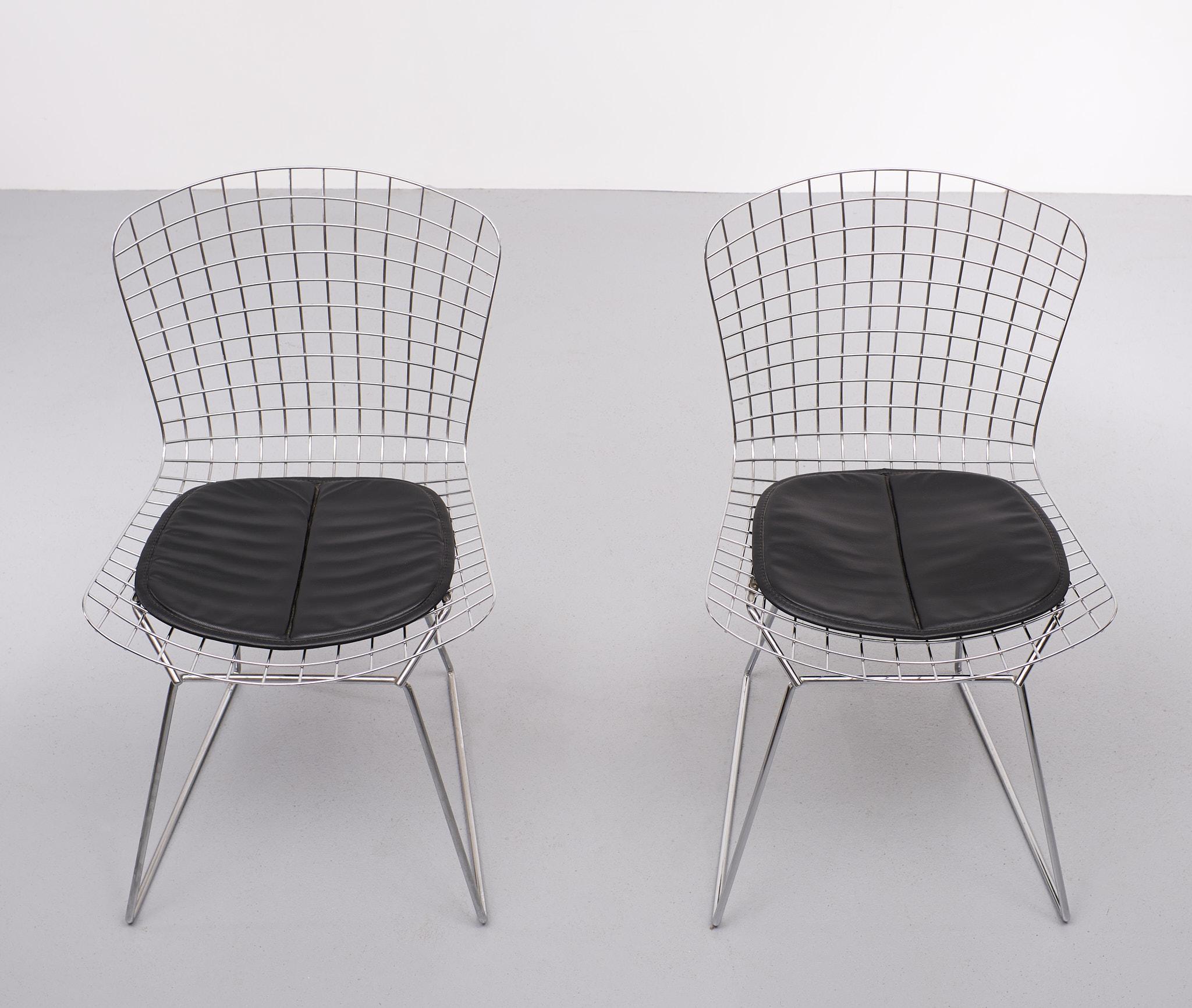 Iconic Harry Bertoia  side chair . Chrome wire chairs .with there slabs ,in 
Black limitation leather. Very good condition . 