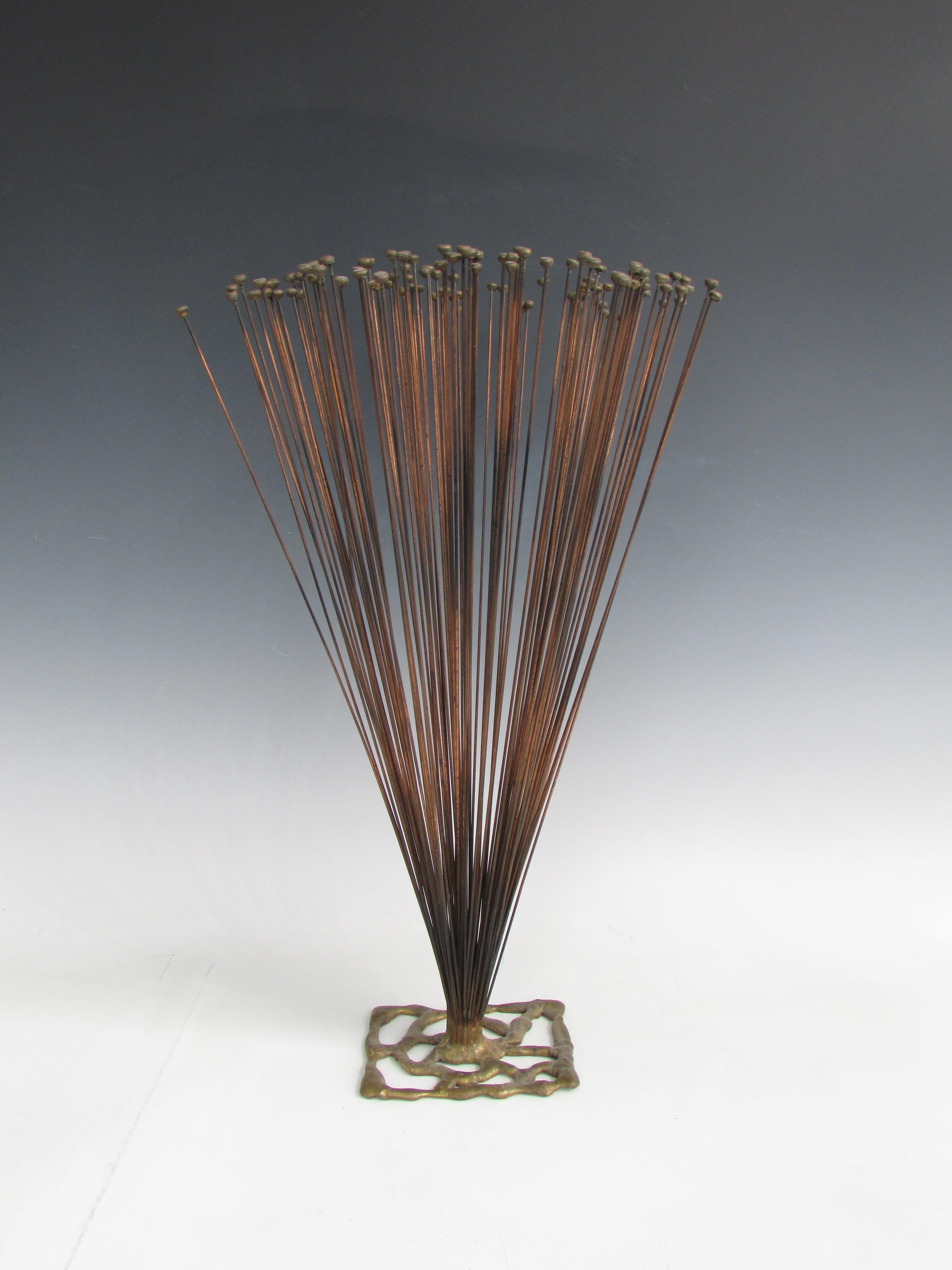 Multiple steel rods set in free form brazed brass base. Each rod topped with melted brass droplet . Not quite but very reminiscent of Harry Bertoias work. Under vibration rods do have Kinetic movement.