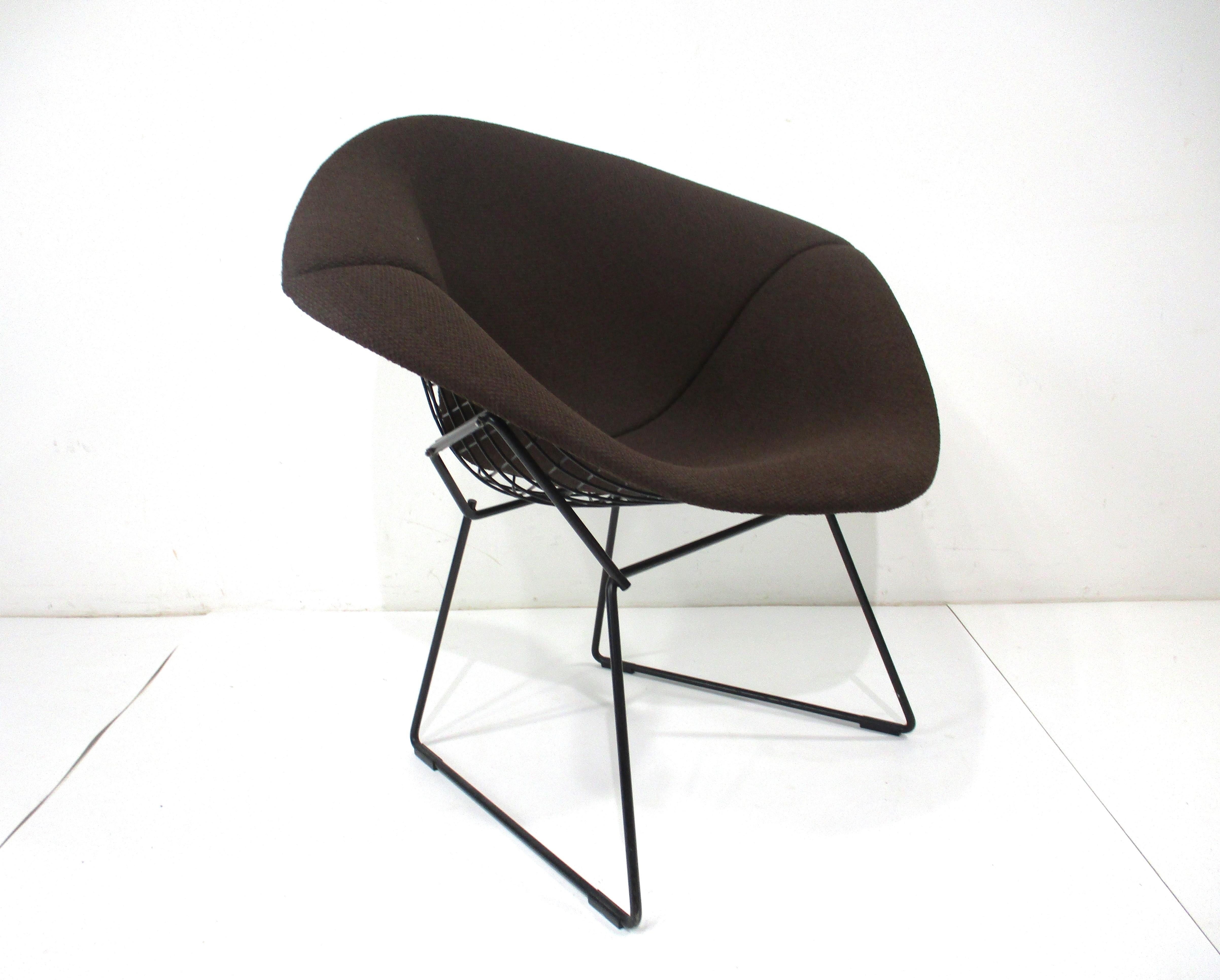 A very nice black wire framed small diamond lounge chair with matching black base . Having a full upholstered cover in a chocolate tone with soft woven fabric making the chair a very cozy place to sit for long periods . Manufactured by Knoll and