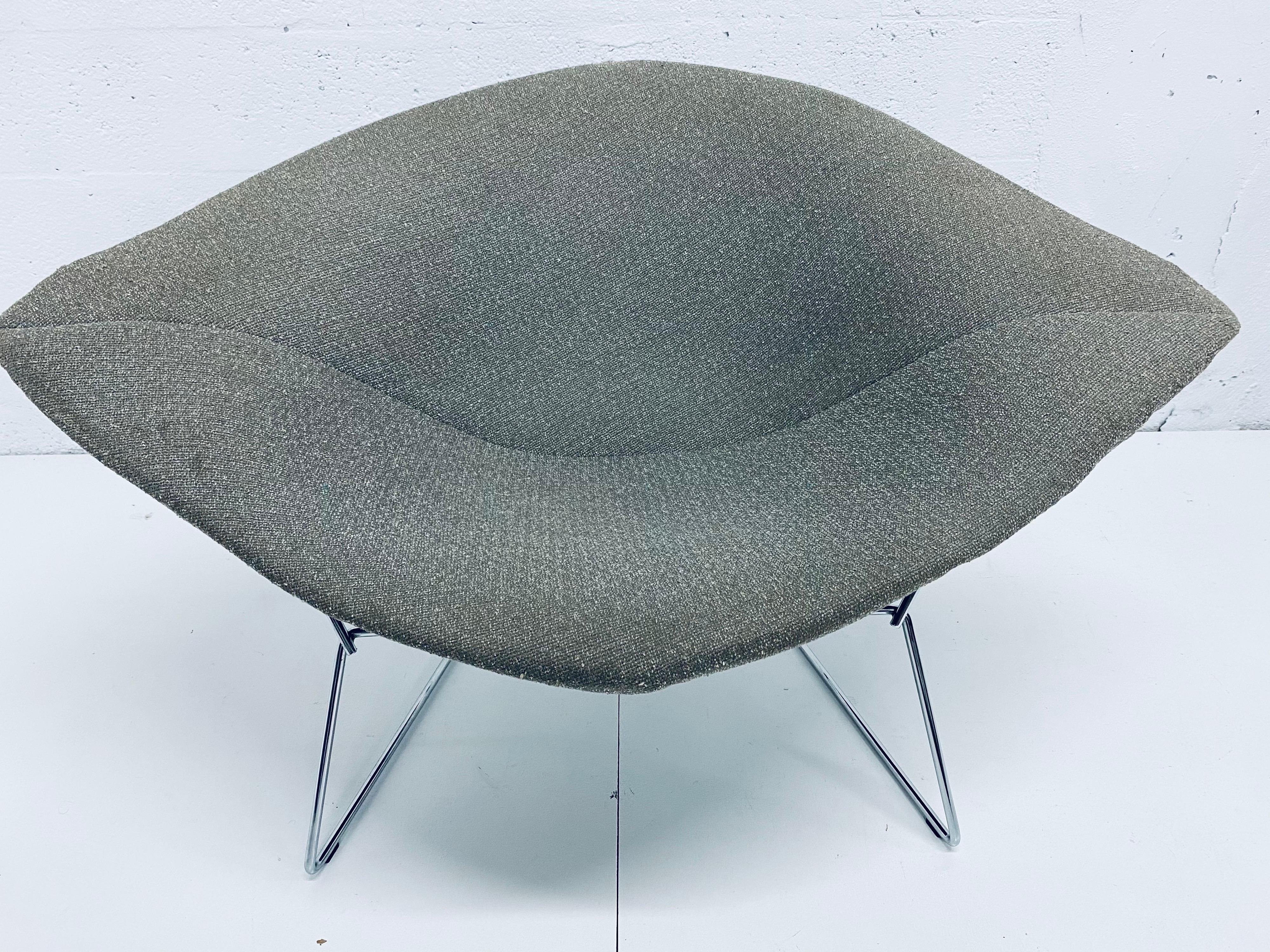 Original wide diamond chair with authentic seat cover from the 1960s designed by Harry Bertoia for Knoll. The upper seat has been professionally powder-coated in satin black and the existing chrome plated base has been polished. Use with the