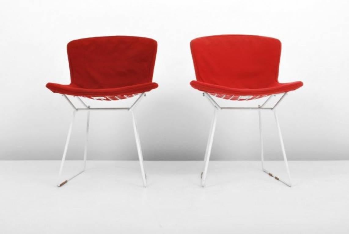 These early production and all original Harry Bertoia for Knoll International wire chairs are one of the most iconic designs of Mid-Century Modernism. The chairs are constructed of welded steel rods with a white powder coated finish and retain the