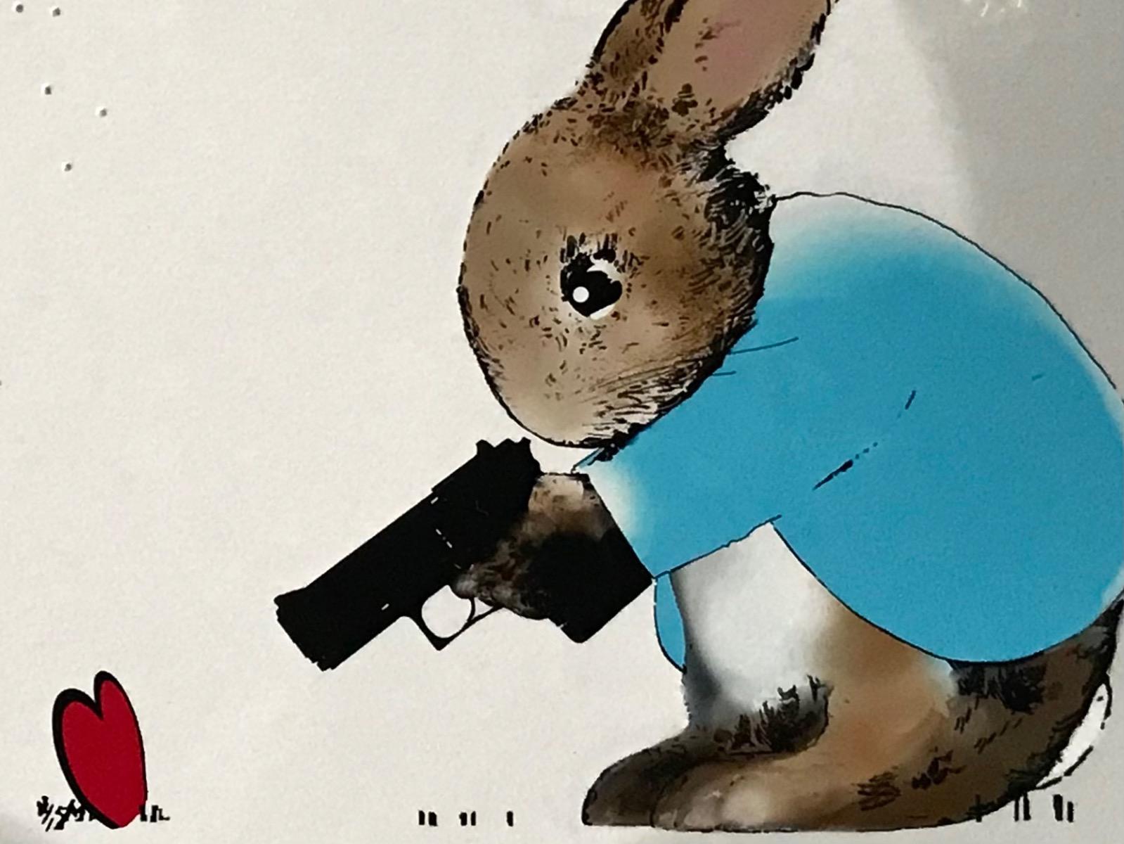 Rural Resistance series- Freeze! by Harry Bunce consists of blue red and brown tones that display a bunny holding a gun pointed at a red heart, wiht the gunshots in the sheet in the background.

Additional information:
Mixed media (archival print
