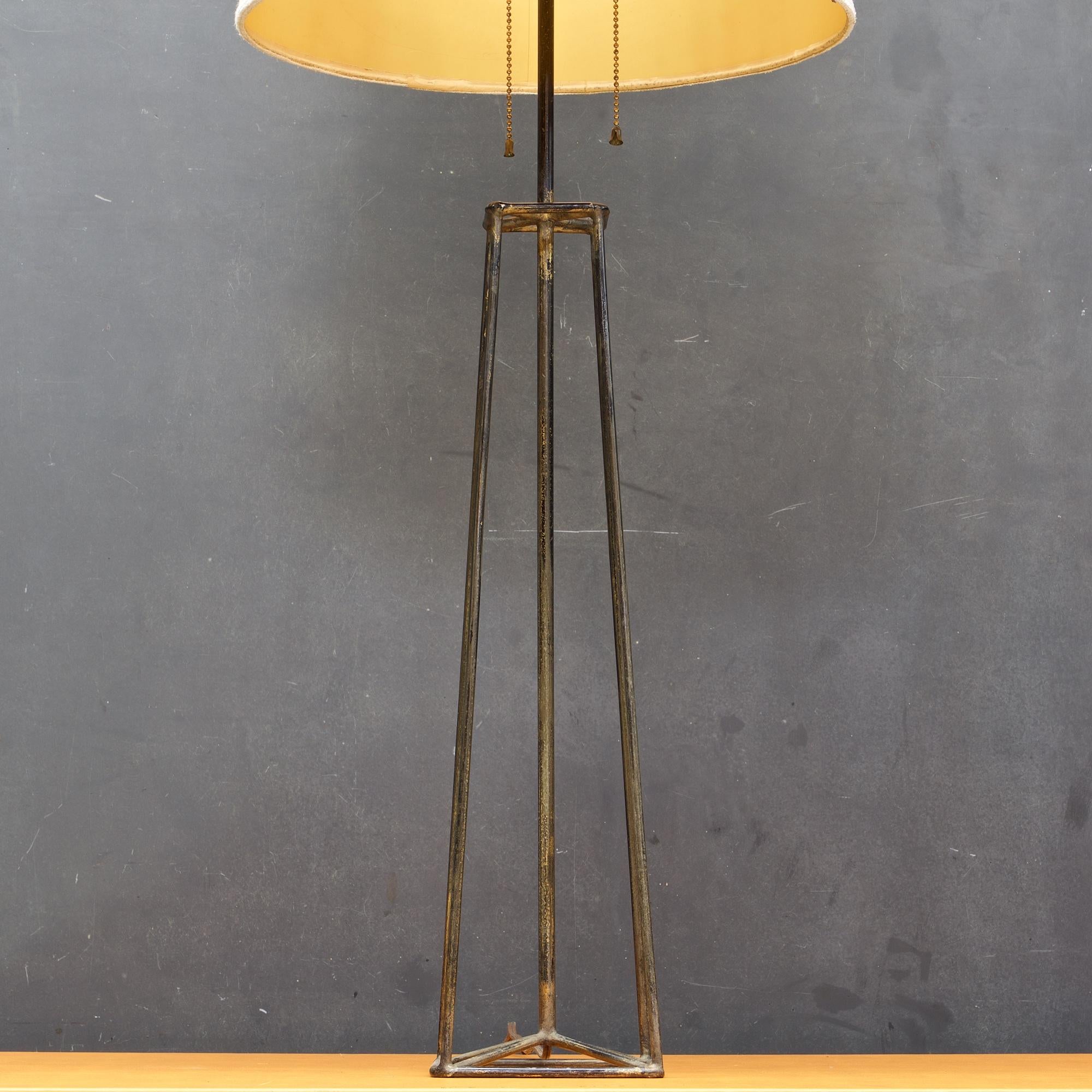 Harry Lawenda for Kneedler-Fauchere. Low production from the early 1950s. Made in San Francisco.

Black enameled Iron frame with a patina of a second paint job of gold paint and wear to original black finish.
Lamp body W 5.5 x D 5.5 x H 21 in.