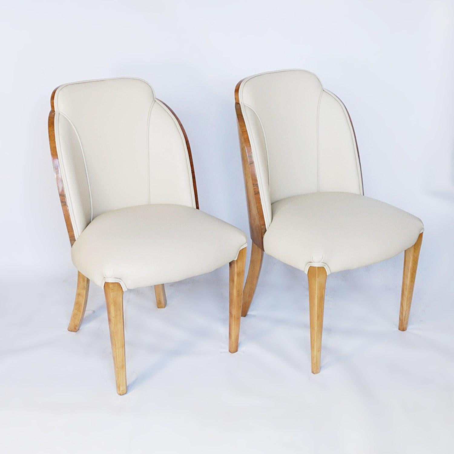 A pair of walnut backed cloud chairs by Harry and Lou Epstein. Burr walnut veneers, upholstered in cream leather. 

Dimensions: Chair H 86cm W 49cm D 47cm, seat H 44cm D 46cm

Origin: English

Date: circa 1930

Item No: 902214

All of our