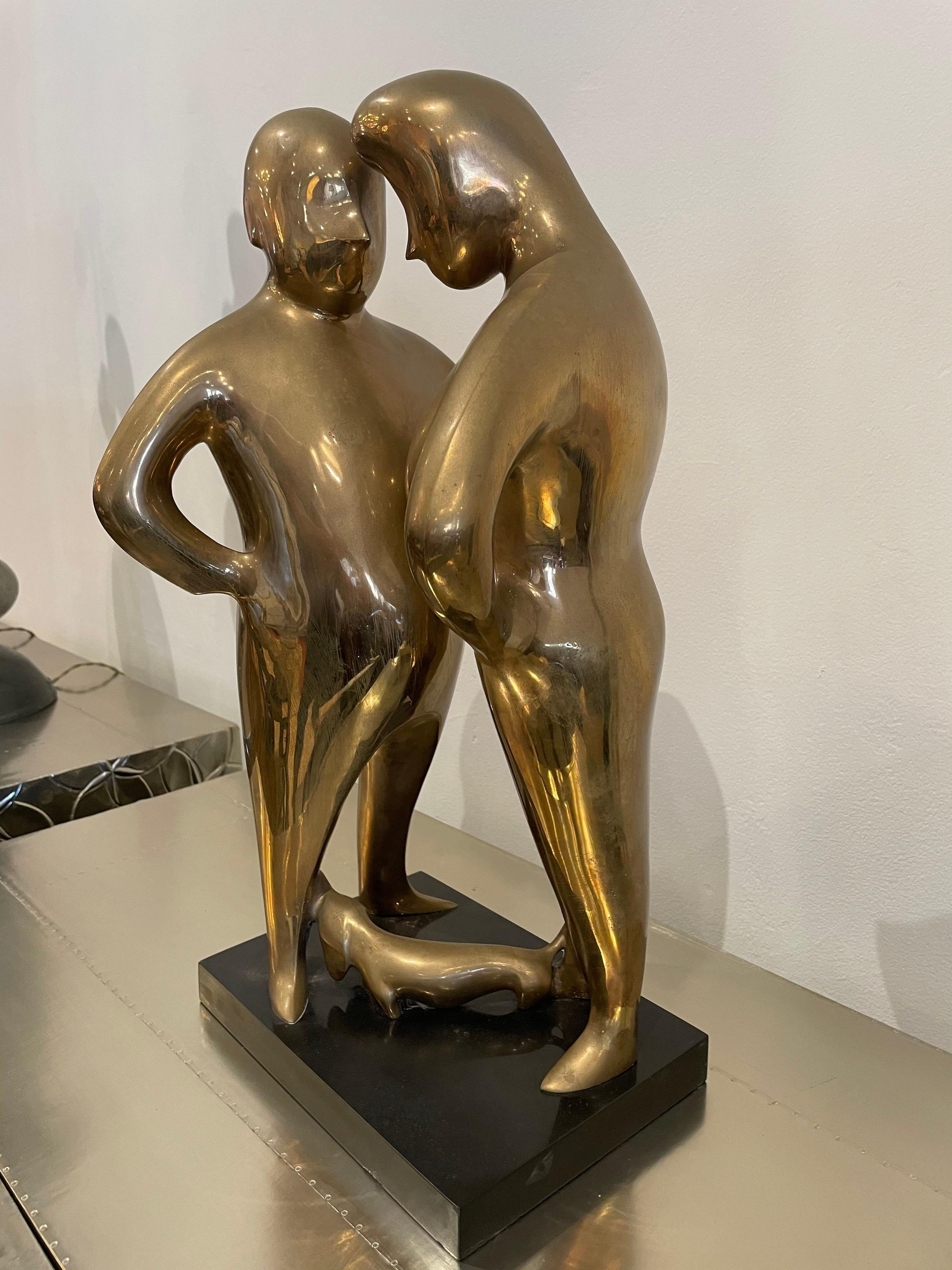 statue of man kissing womans feet