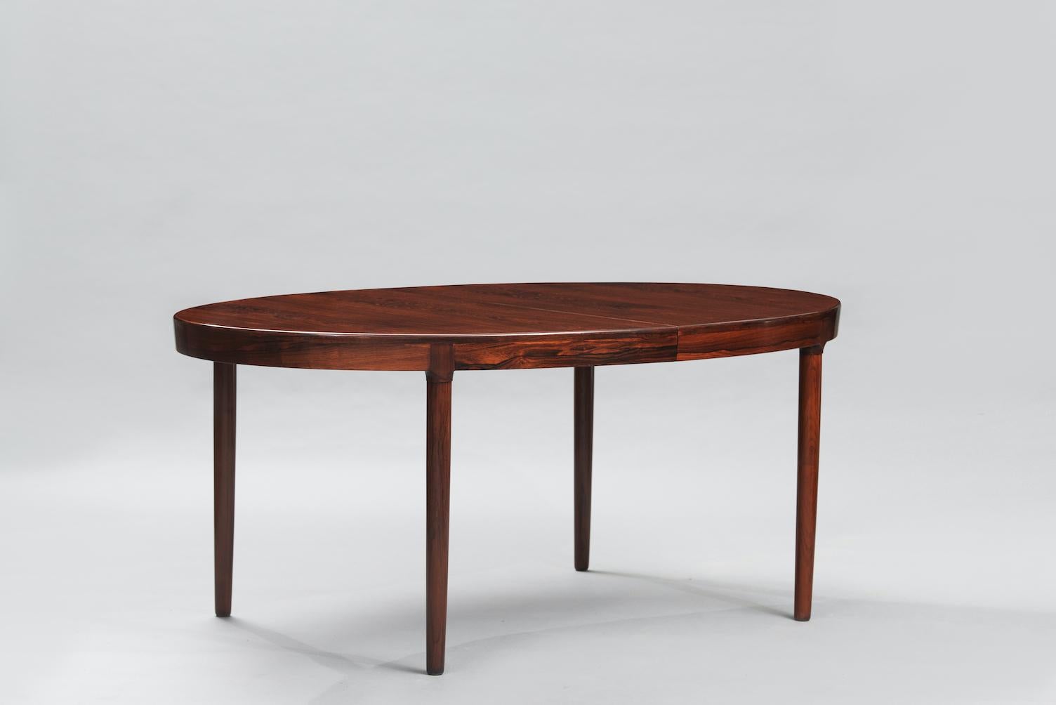 Harry Ostergaard extendable rosewood oval dining table produced by Randers Mobelfabrik.
Measures: Width: 270cm (open), 170cm (closed).