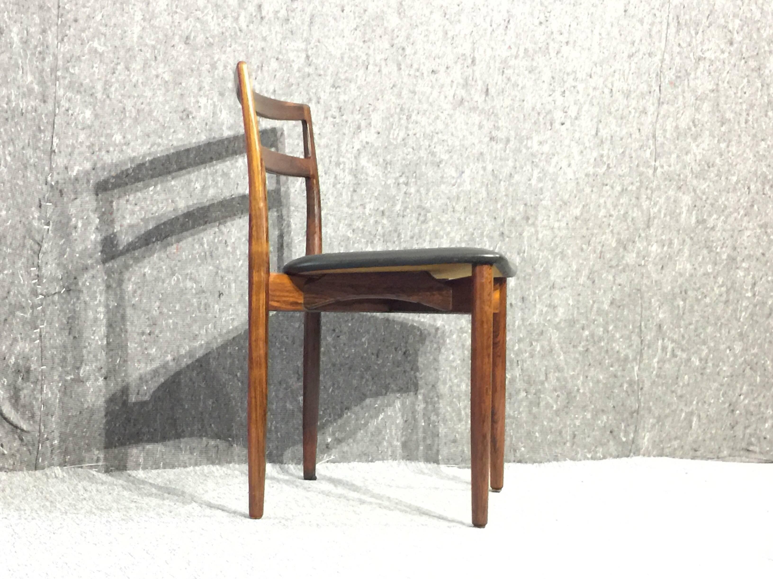 Stunning dining chairs designed by Harry Østergaard in the 1960s and produced by Randers Møbelfabrik. The frame is made out of rosewood and upholstery in black leather.