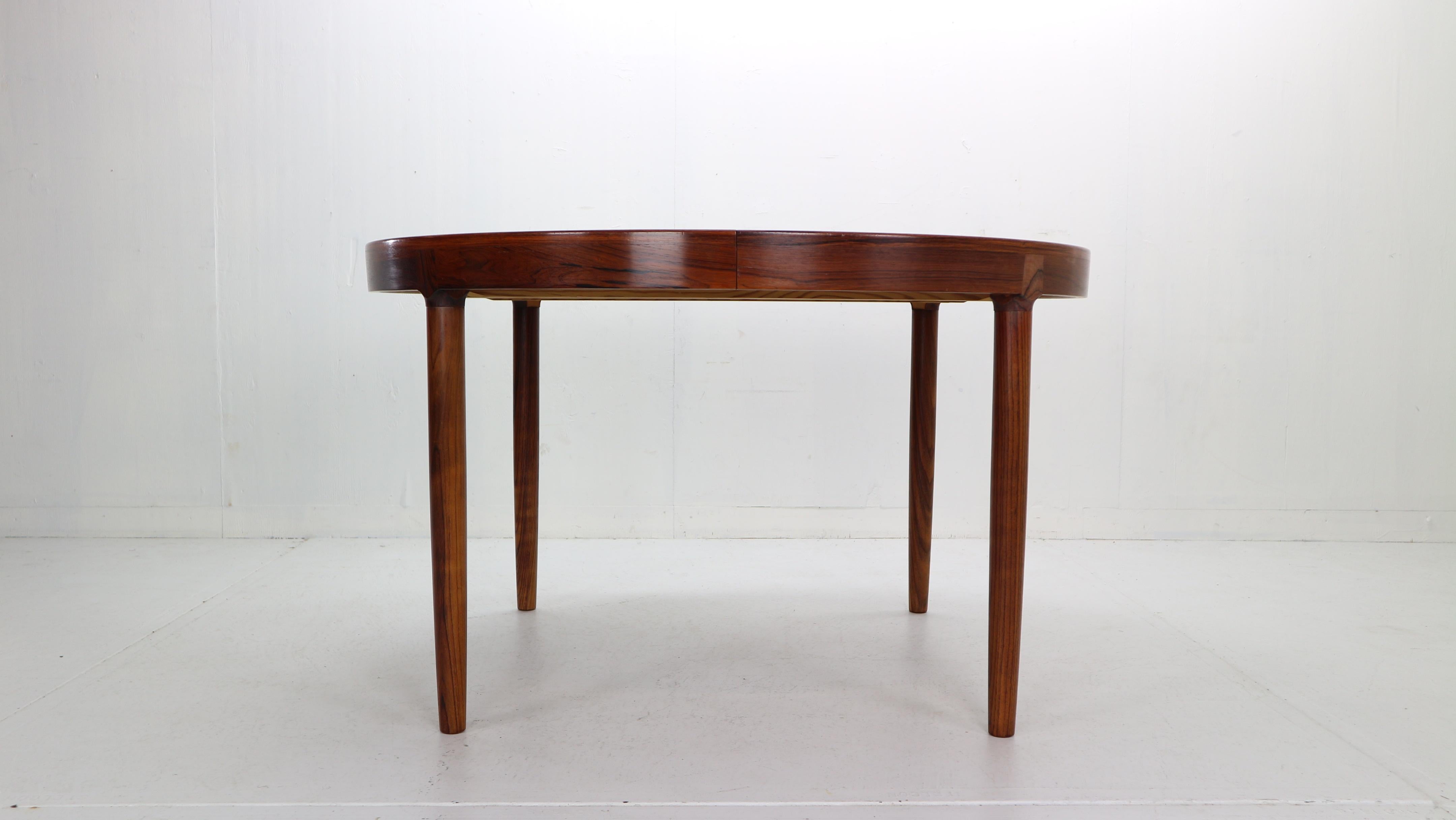 Exceptional dinning table designwed by Harry Østergaard for Randers Møbelfabrik manufacture in 1960s period, Denmark.
The table is made of solid rosewood with beautiful wooden paternities over all. 
Beautiful and unusual round leg joints and apron