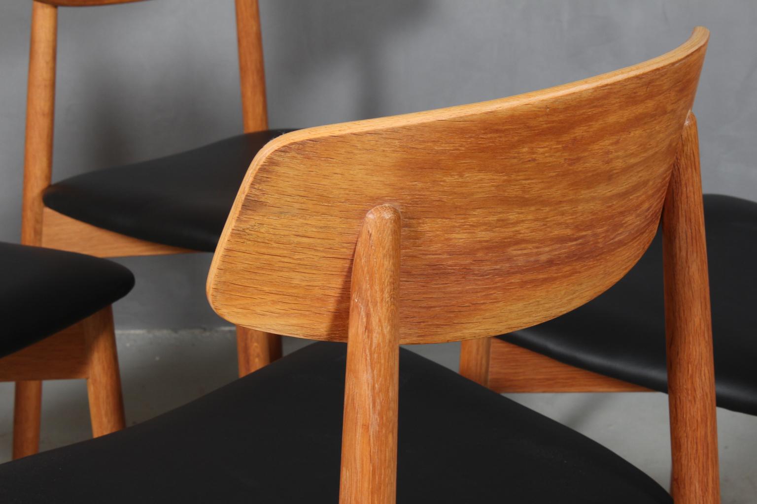Scandinavian Modern Harry Østergaard, Four Chairs in Oak and Black Leather, 1970s