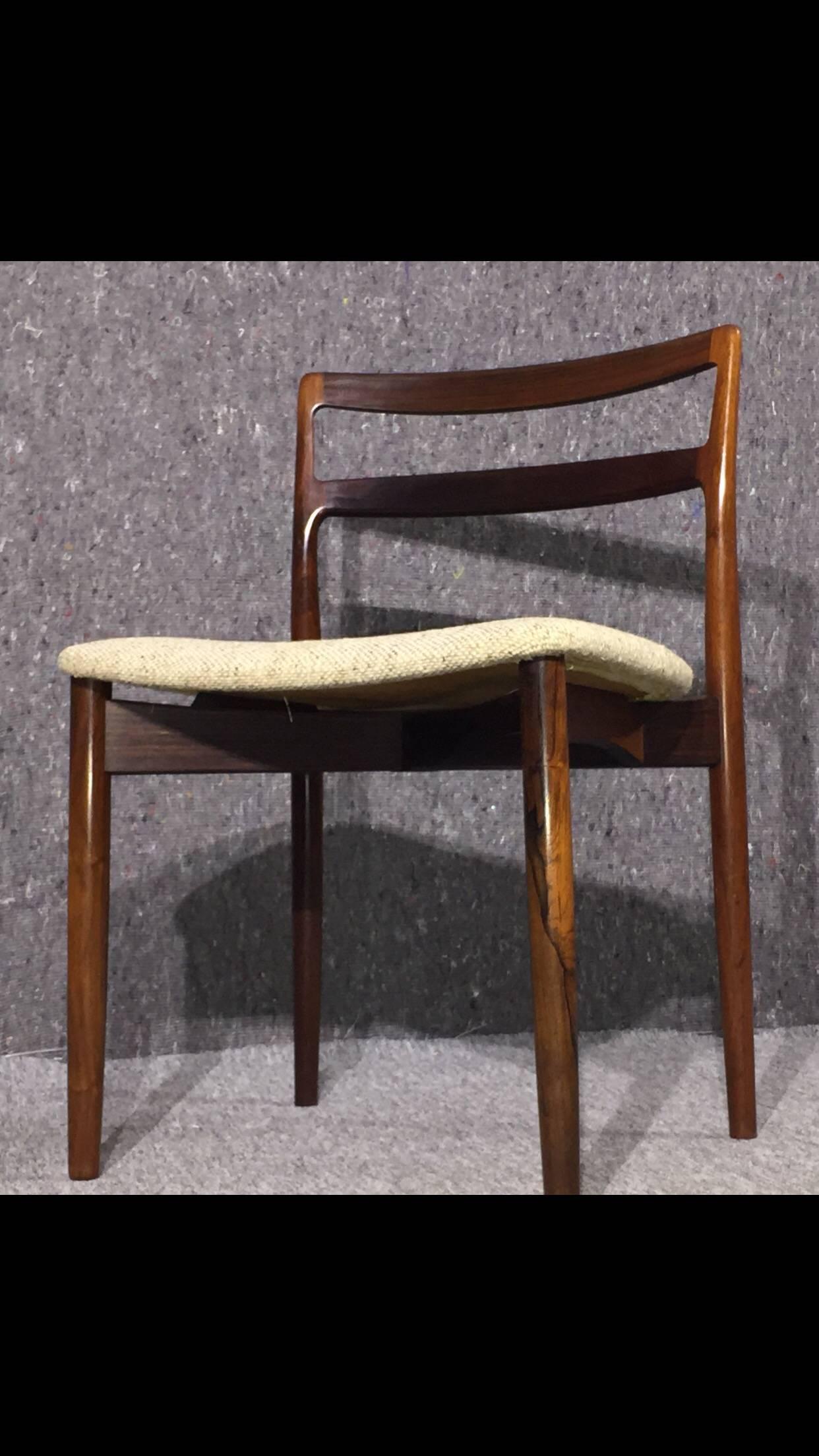 Stunning dining room chairs designed by Harry Østergaard in the 1960s and produced by Randers Møbelfabrik. The frame is made out of rosewood and upholstery in light fabric.