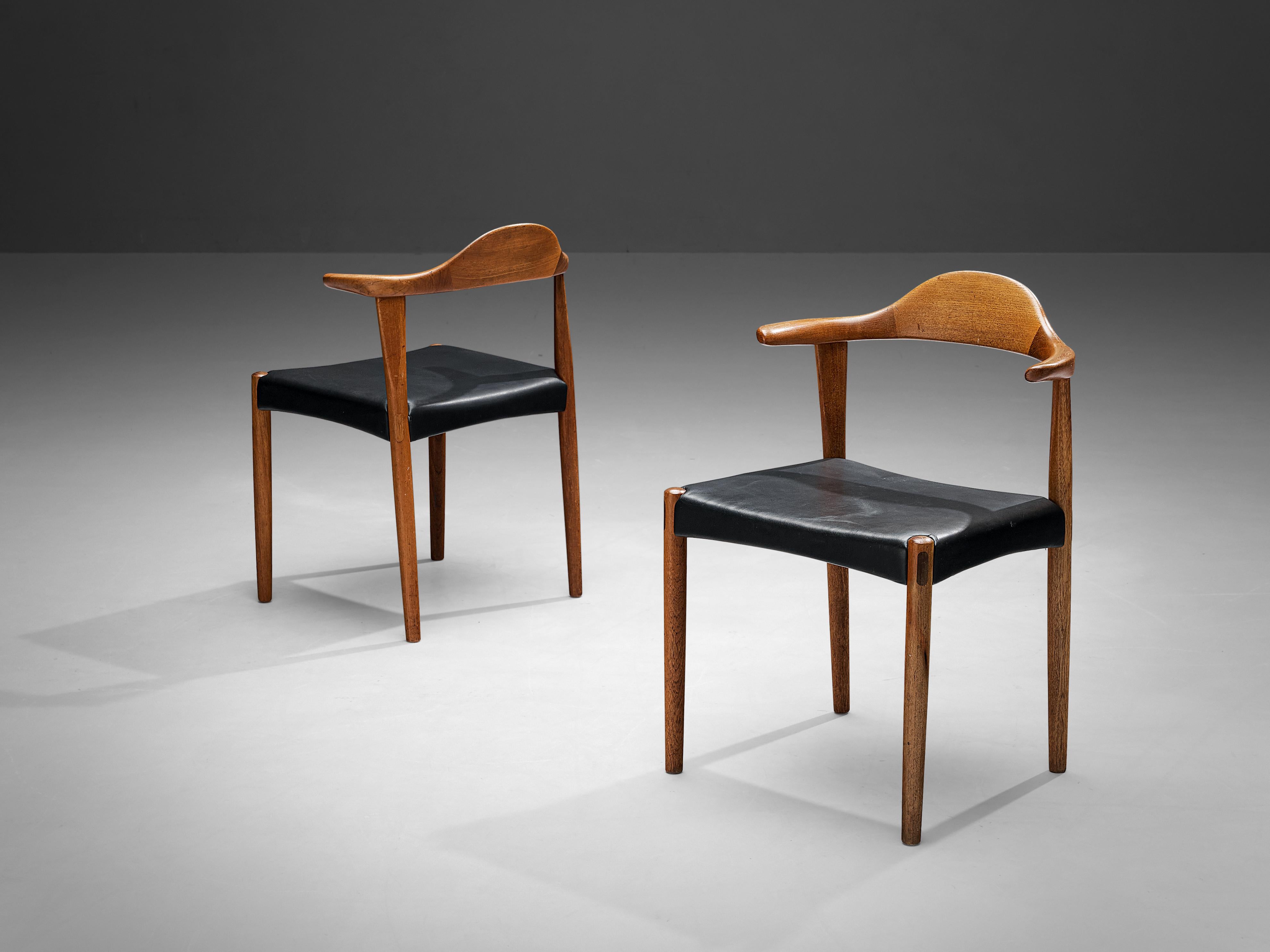 Harry Østergaard for Randers Møbelfabrik, 'Bull Horn' chairs, teak, leatherette, 1950s.

This pair of teak dining chairs with iconic 'Bull Horn' armrests, designed by Harry Østergaard for Randers Møbelfabrik in the 1950s. Constructed of solid teak