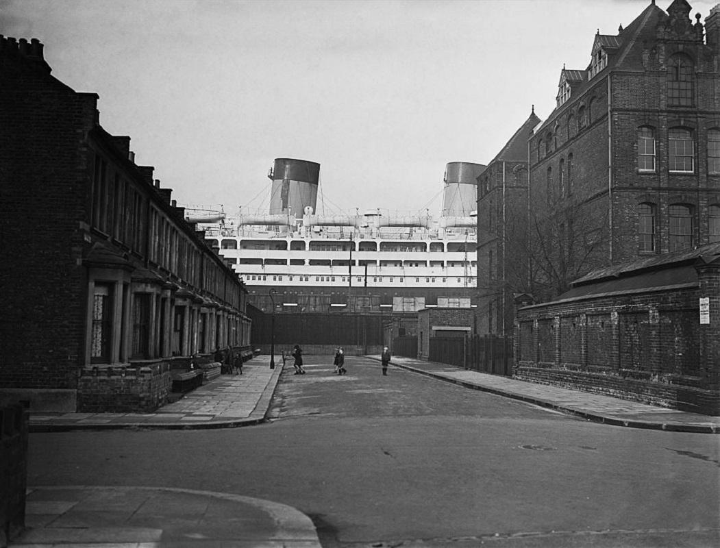 "Dominion Monarch" by Harry Todd

The 26,263 ton Shaw Savill liner Dominion Monarch dwarfs the surrounding houses in Saville Road from her dry dock at the King George V docks in London's Silvertown.

Unframed
Paper Size: 30" x 40'' (inches)
Printed