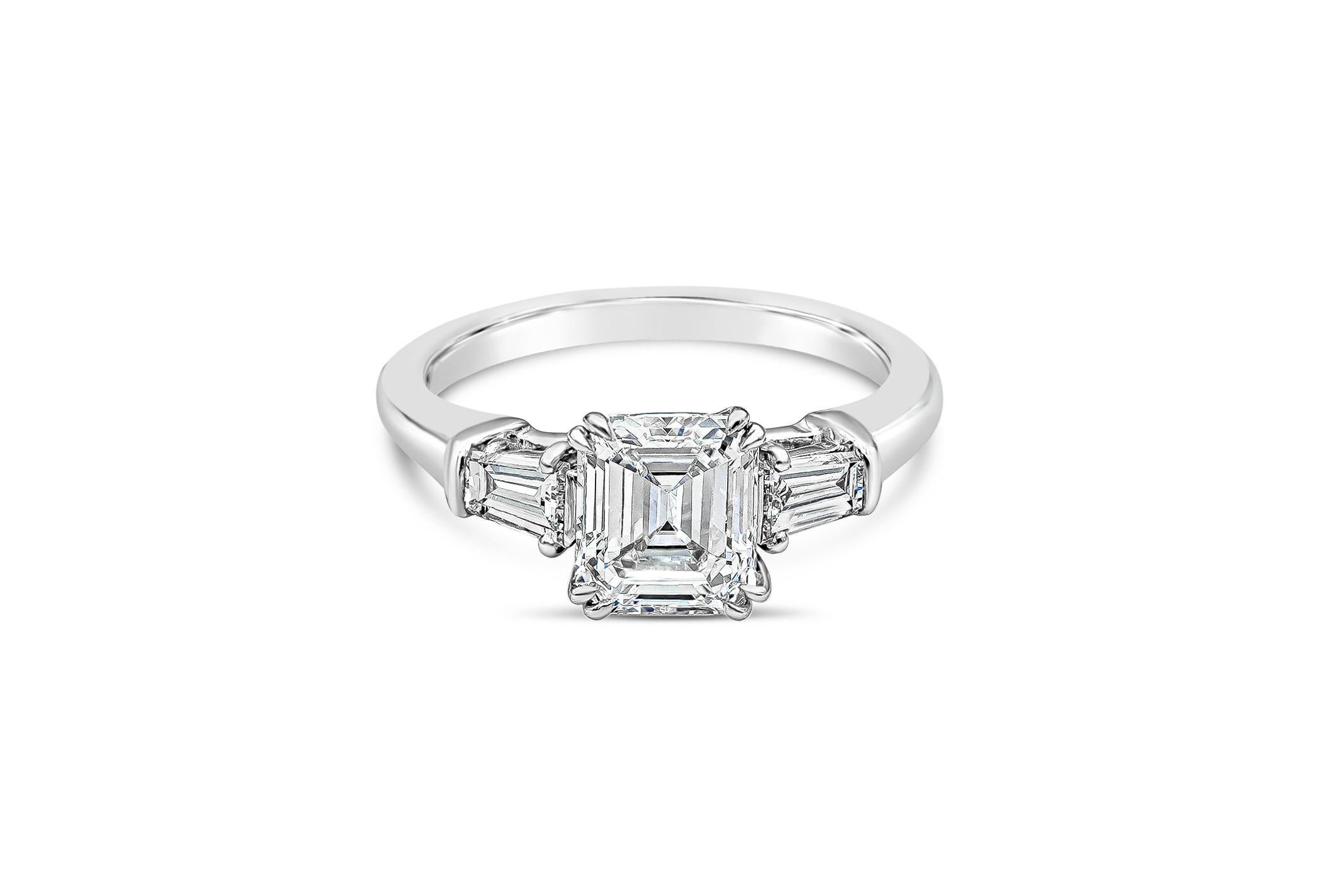 A classic and timeless engagement ring style from world-renowned jeweler, Harry Winston. Showcasing a 1.11 carat emerald cut diamond set in double eagle claws. Flanked by tapered baguette diamonds on either side weighing 0.40 carats total. Made in