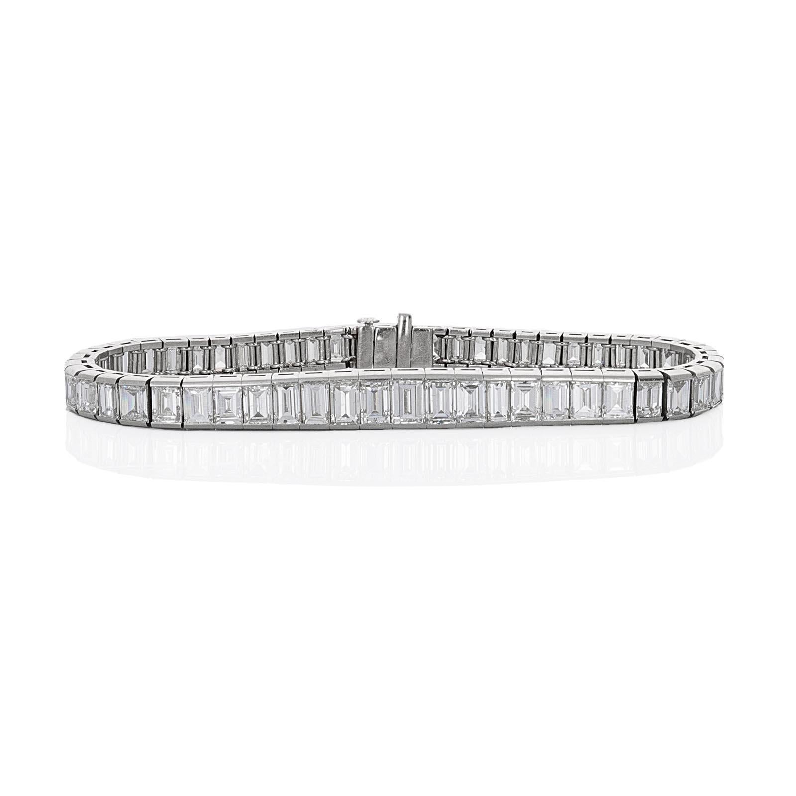 Harry Winston, 1950's, straight line emerald cut diamond platinum tennis bracelet. The bracelet was made beautifully and has been kept in pristine condition. There are a total of 56 emerald cut diamonds with a known weight of 15.47 carats. The