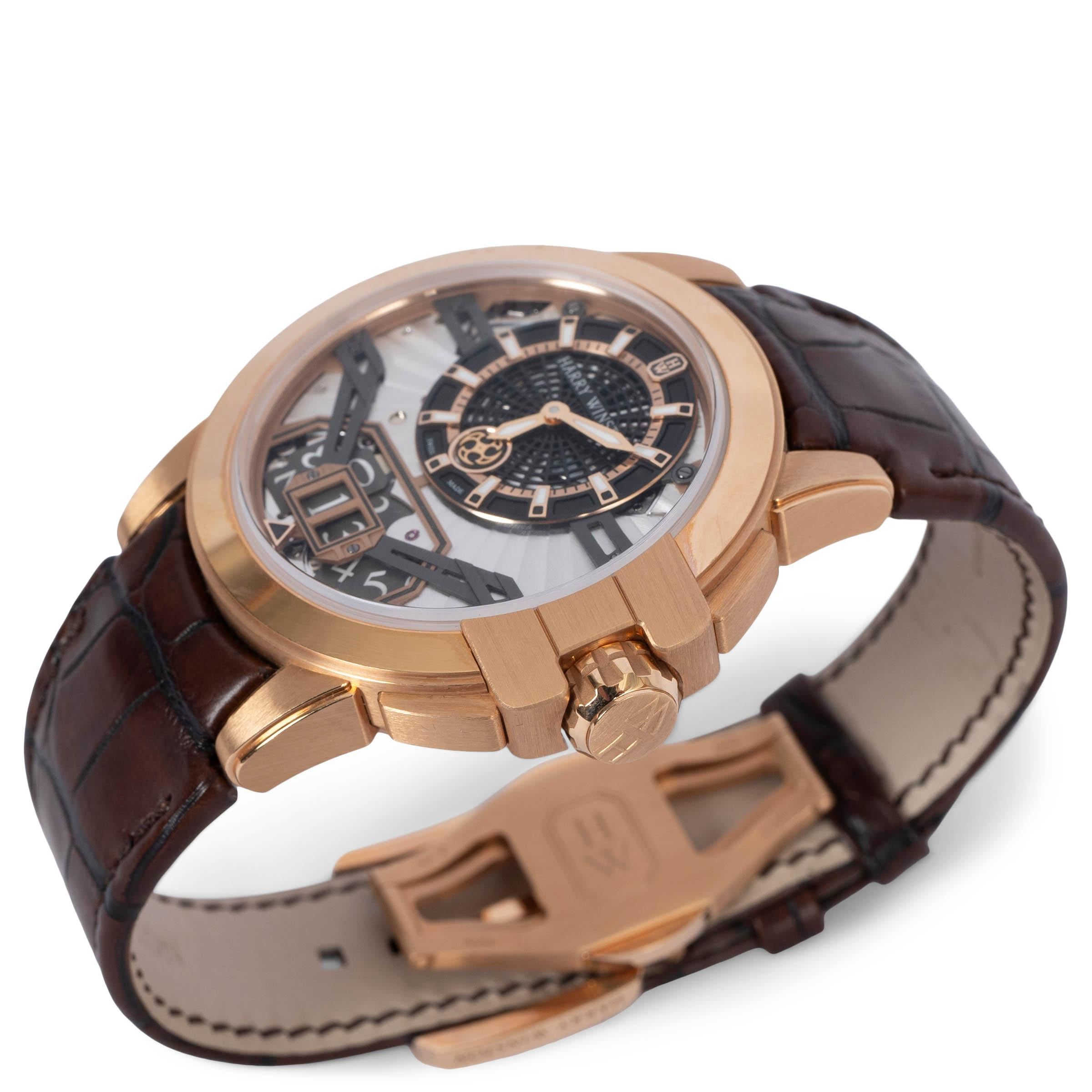 100% authentic Harry Winston Ocean Big Date 42mm watch in 18k rose gold. Openworked dial with big date window, luminescent hands and indexes. Open back. Dark brown matte alligator strap. Brand new - please note the is a tiny scartch on the bezel.
