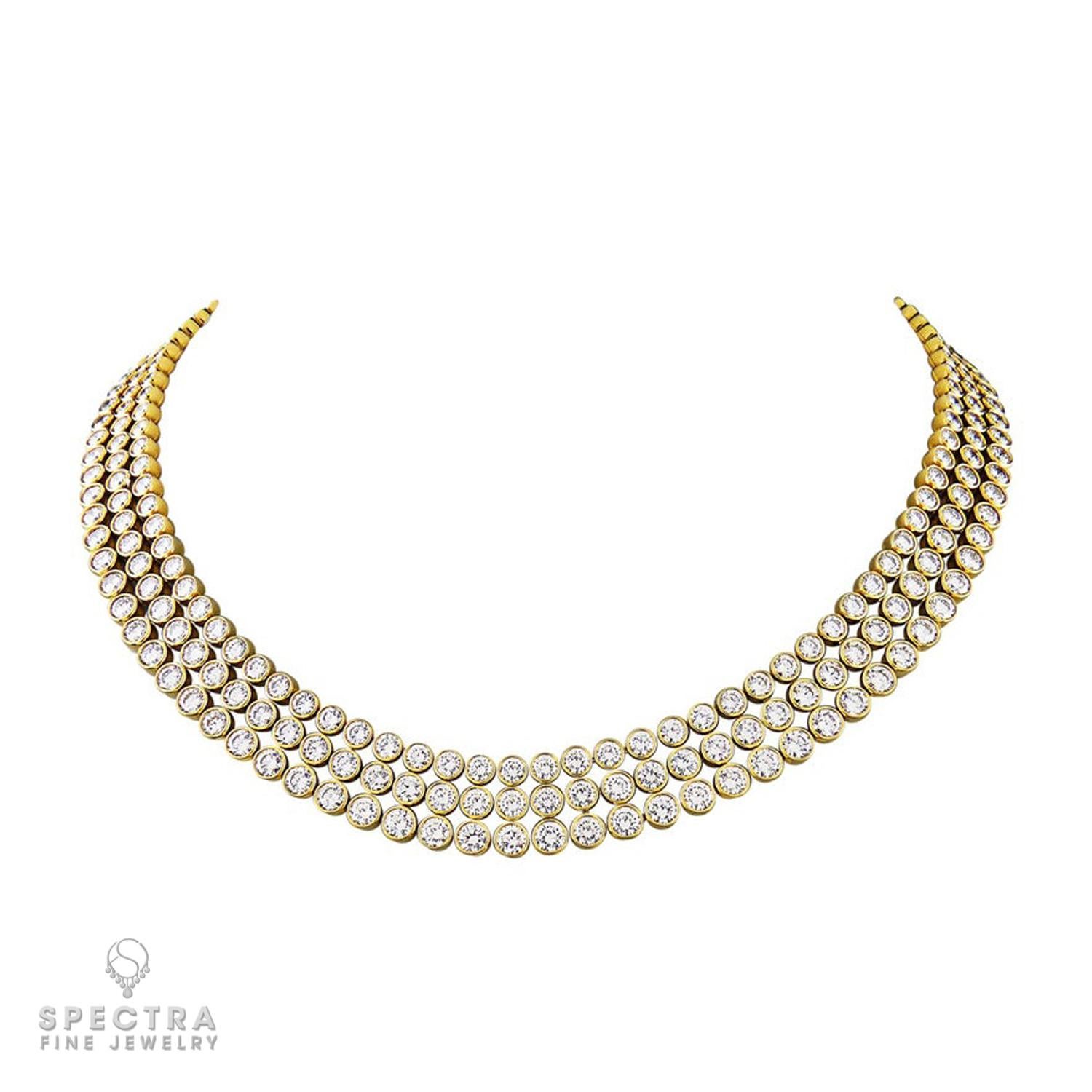 This understated yet grand Harry Winston Diamond 3-Row Riviere Necklace, made in the late XX century, is crafted in 18K yellow gold and features 282 round brilliant bezel-set diamonds with an estimated total weight of 68 carats of E-F color and VVS
